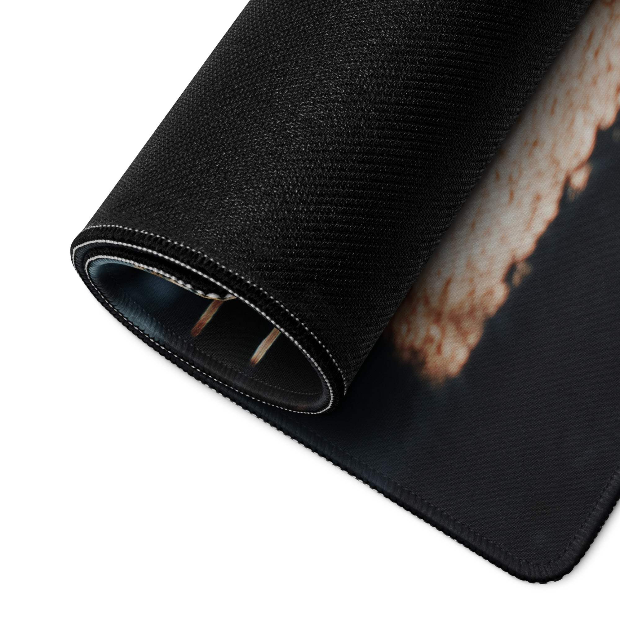Black textured gaming mousepad with rolled edge, white stitching, non-slip base