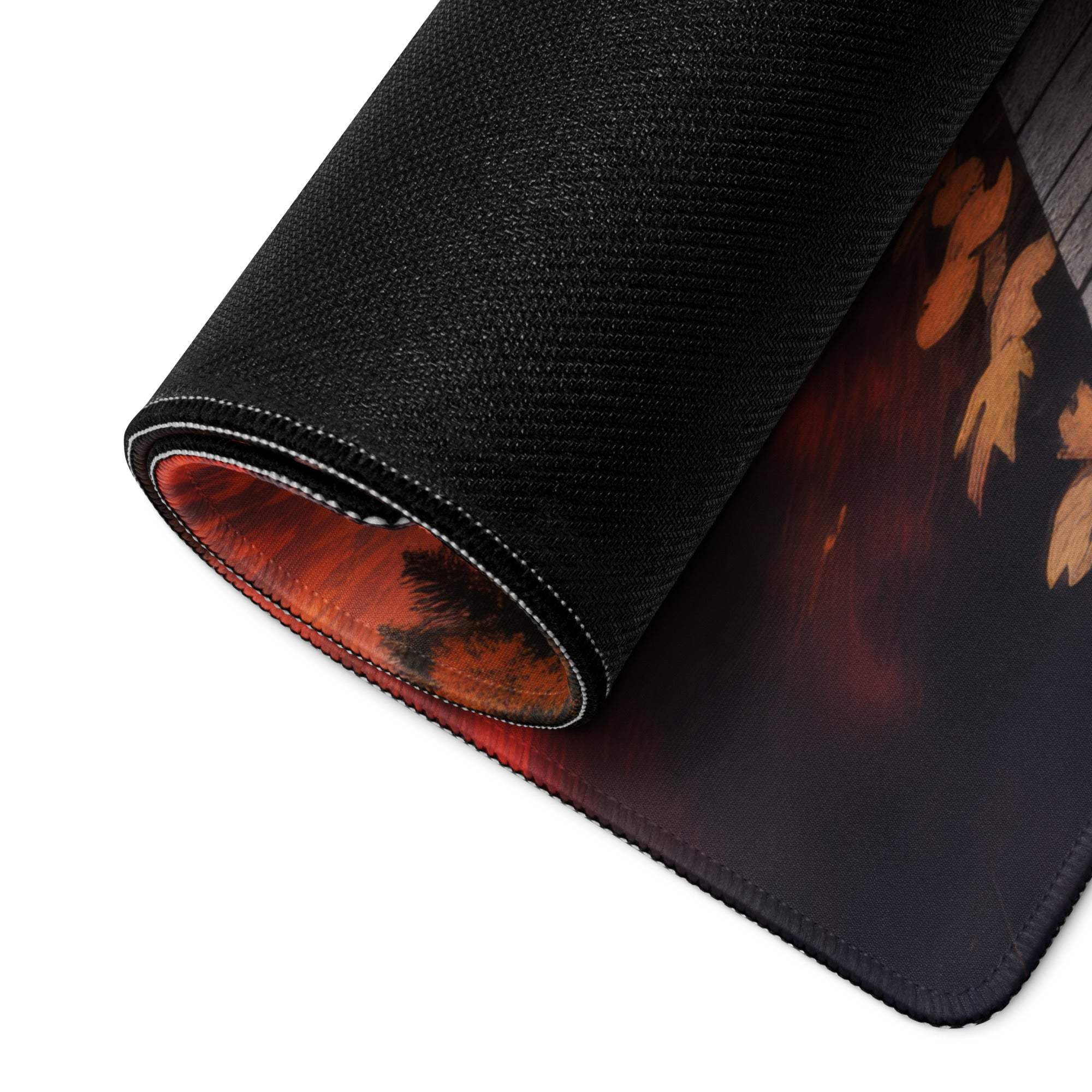 Black gaming mousepad with fiery orange red autumn leaf design