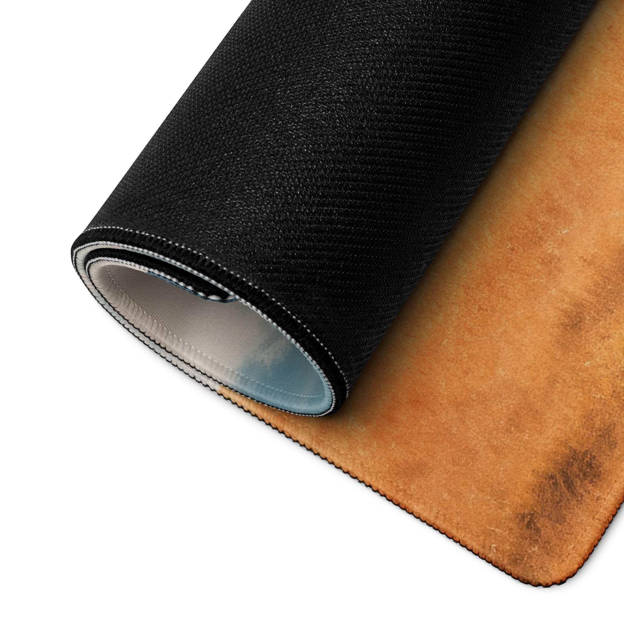 Rolled black and tan leather gaming mousepad showing textured layered construction