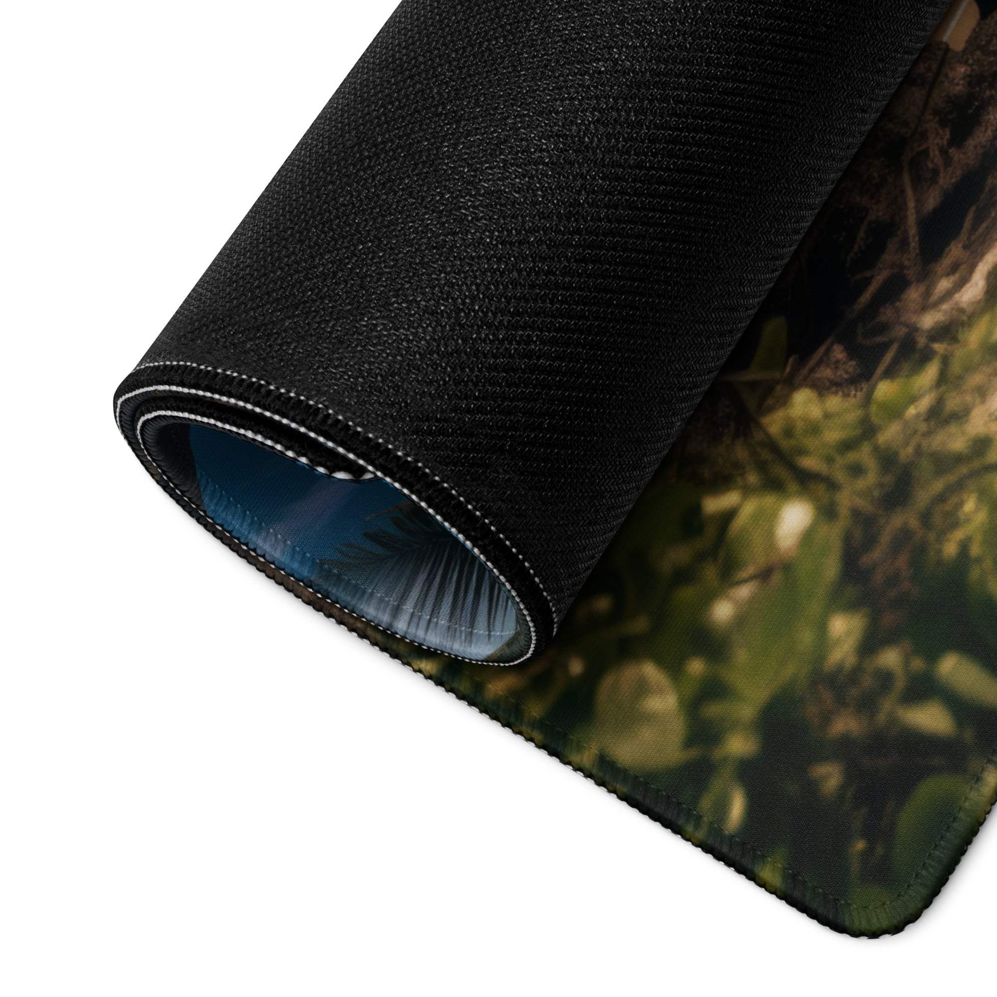 Black textured camouflage forest mousepad with white stitching