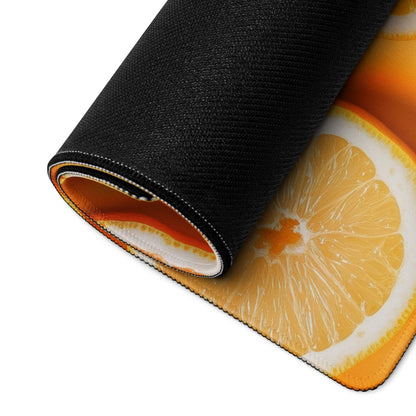 Black rolled-up mousepad with vibrant orange slice design and non-slip backing