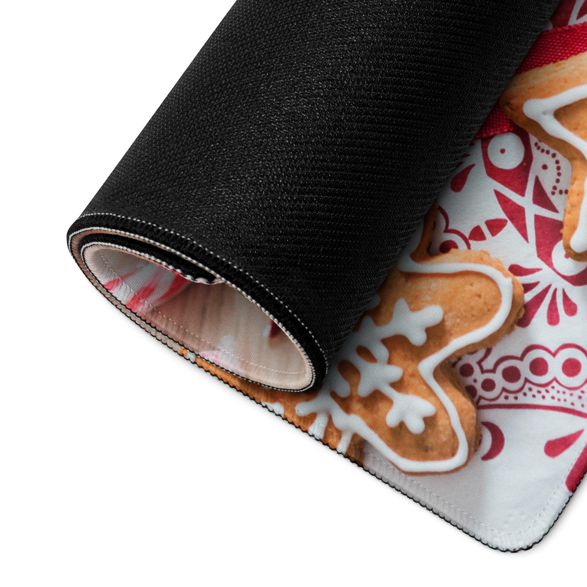 Rolled-up black Festive Holiday gaming mouse pad with gingerbread cookie design