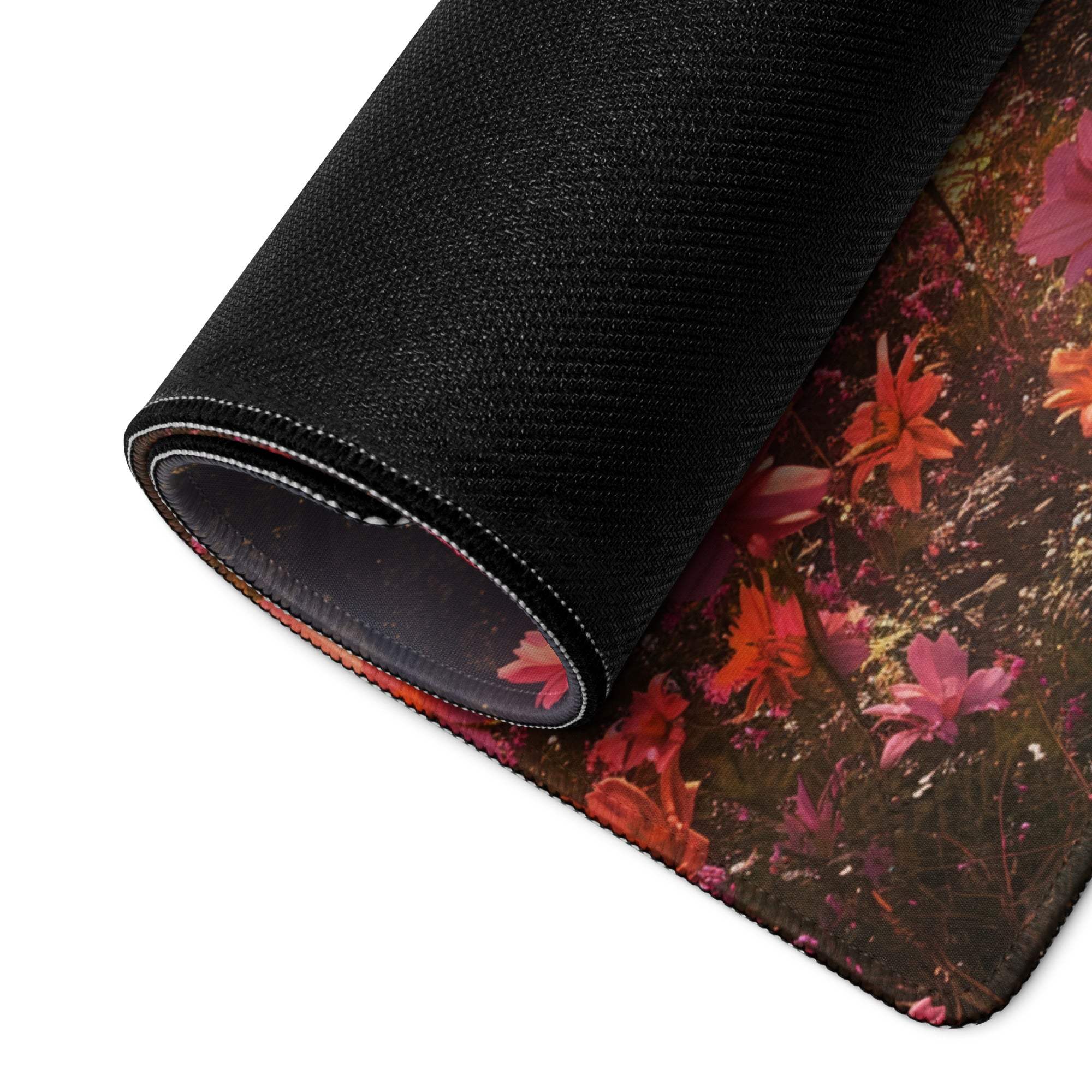 Rolled-up Floral Garden gaming mouse pad with vibrant pink blossoms