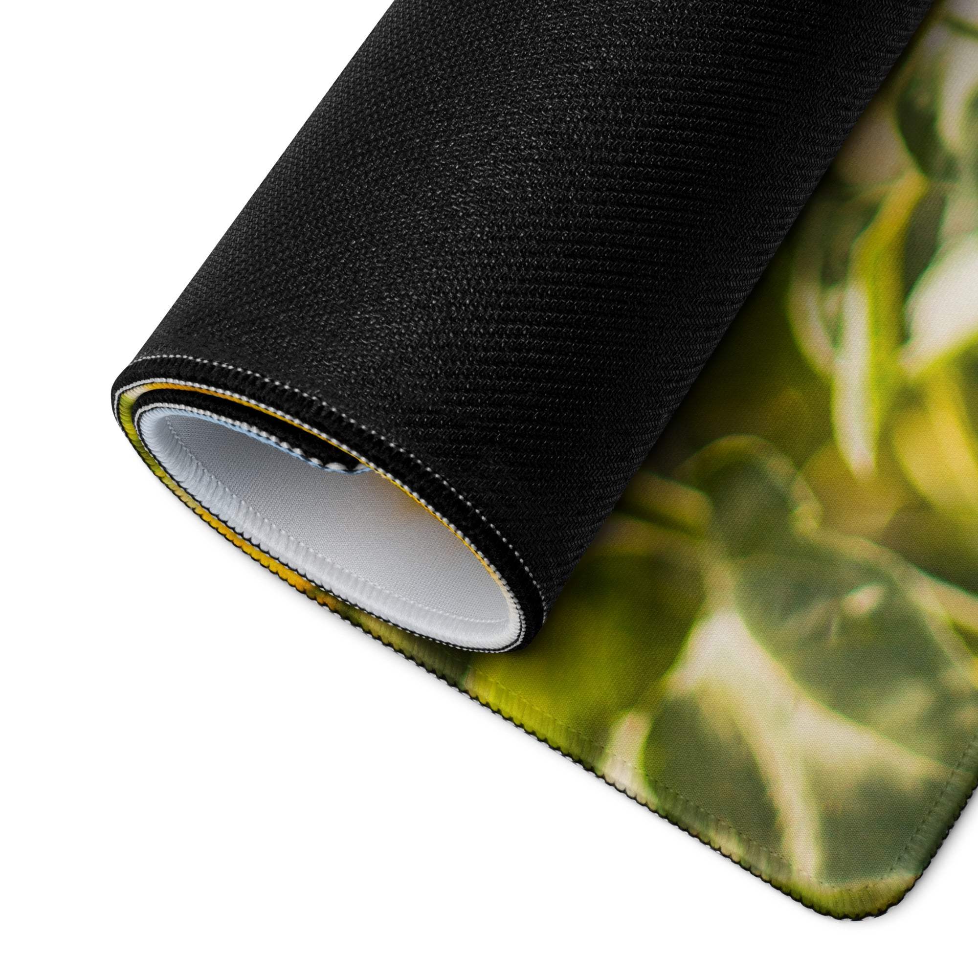 Rolled-up vibrant sunflower field gaming mouse pad with green leafy design