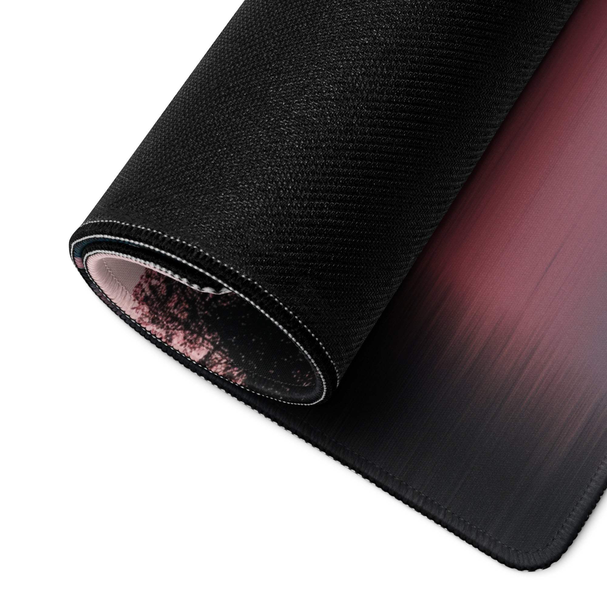 Black textured gaming mousepad with pink-to-black gradient, stitched edges