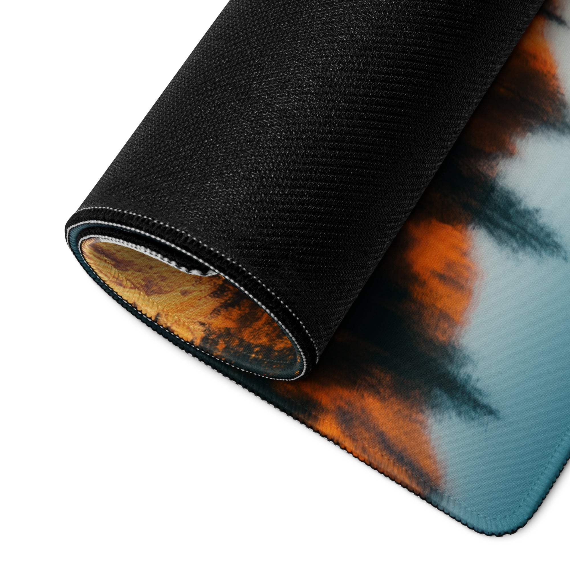 Black textured gaming mousepad with orange teal clouds and stitched edges