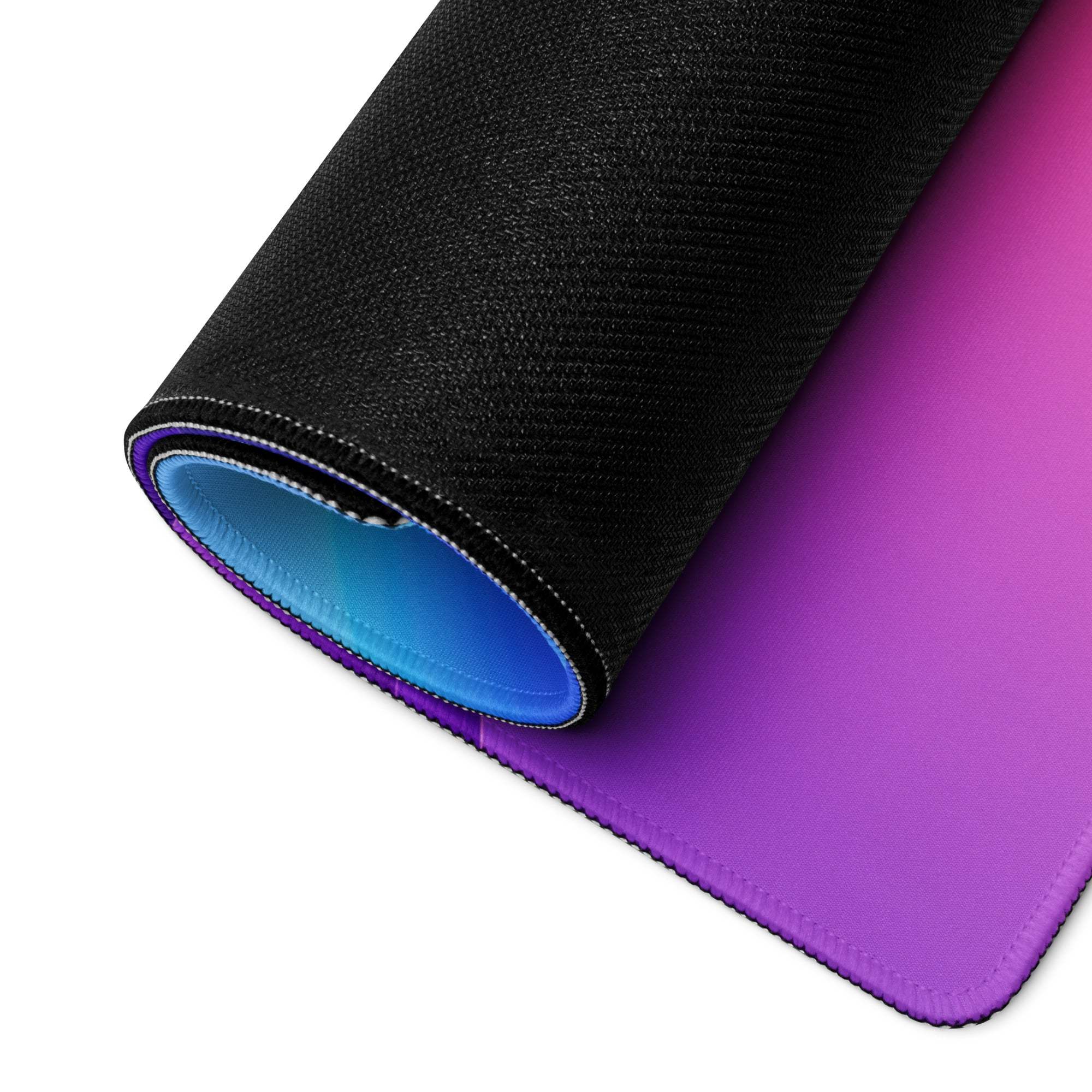Rolled-up vibrant purple gradient gaming mouse pad with non-slip base