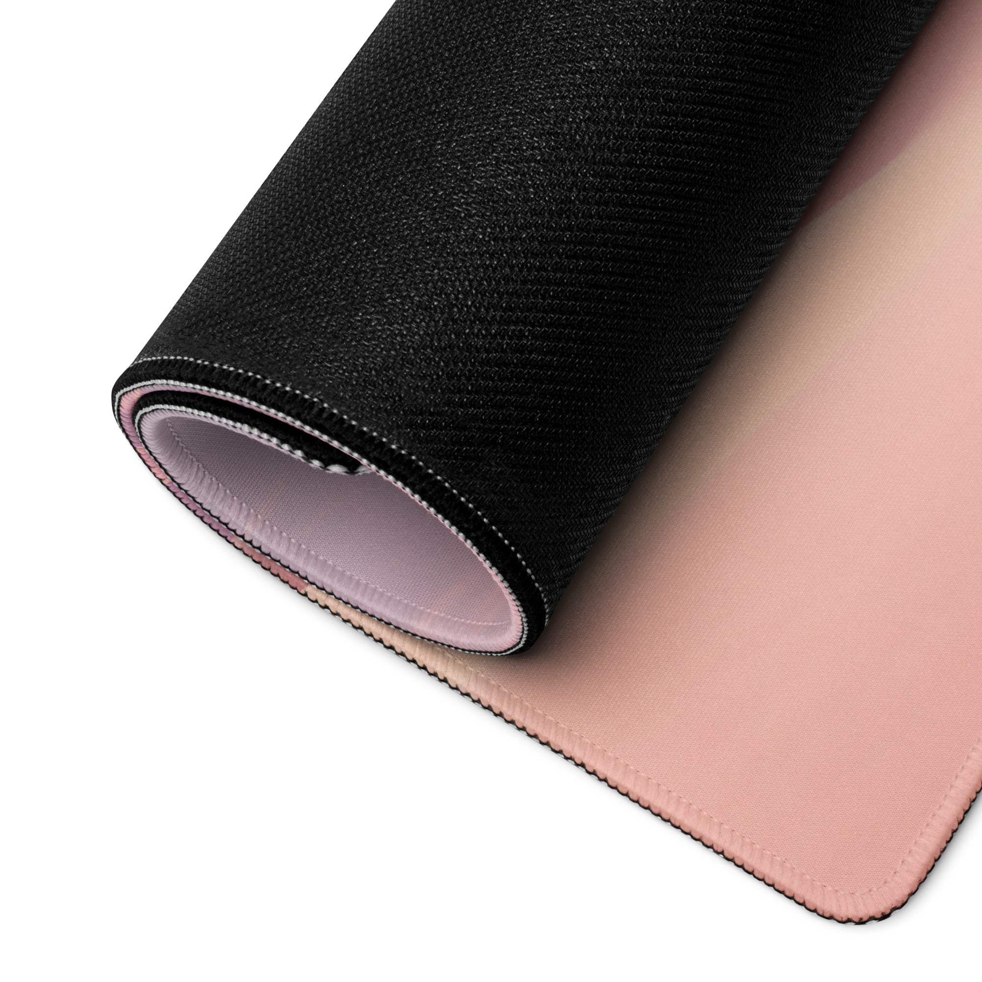 Rolled-up Pastel Desert Dunes pink black gaming mousepad with stitched edges
