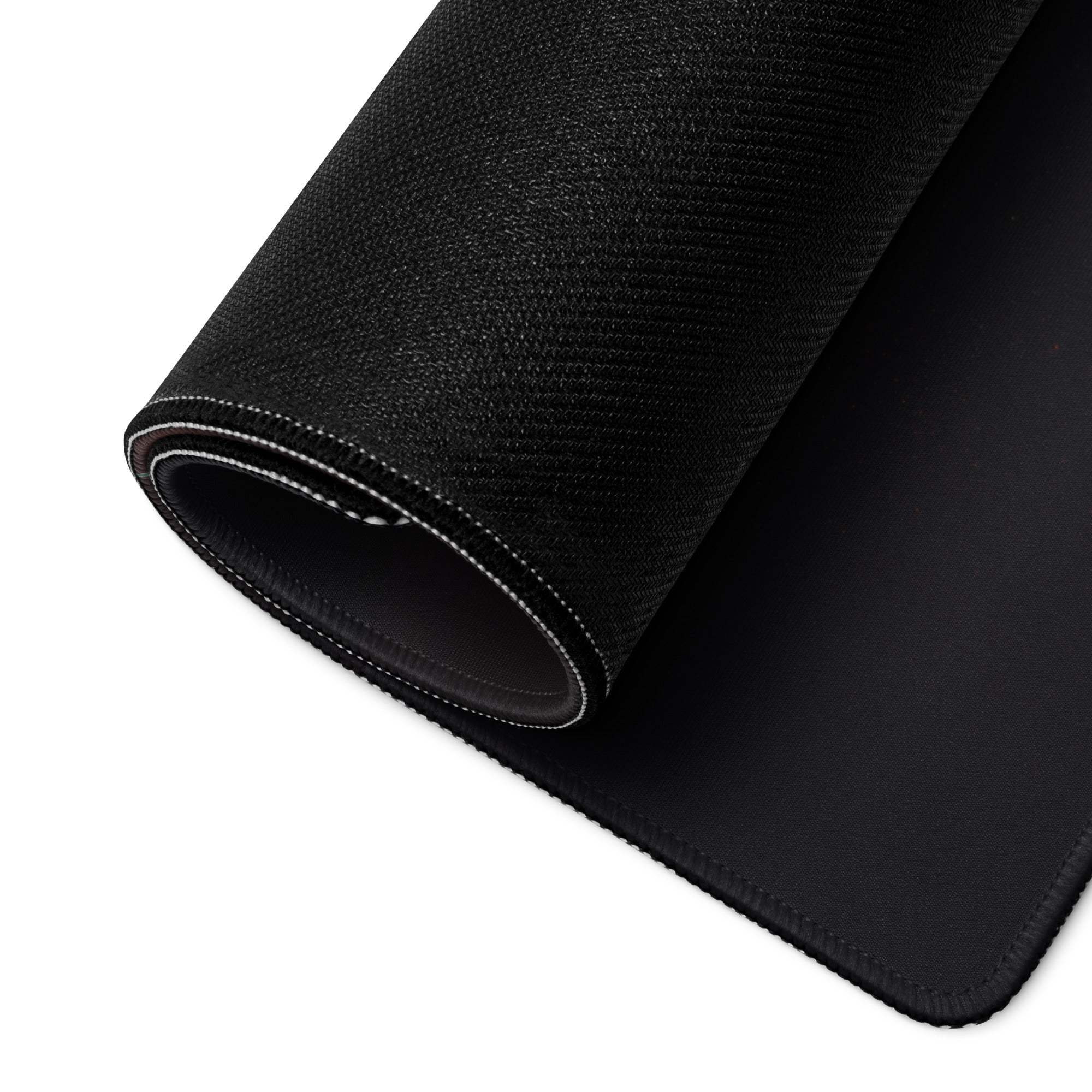 Black textured oversized gaming mousepad with stitched edges, neon blue glow