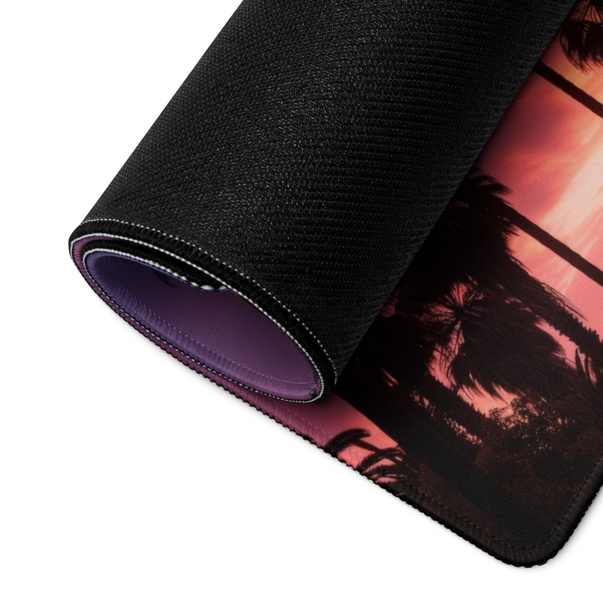 Large black textured gaming mouse pad with sunset palm trees design, purple lining, non-slip backing