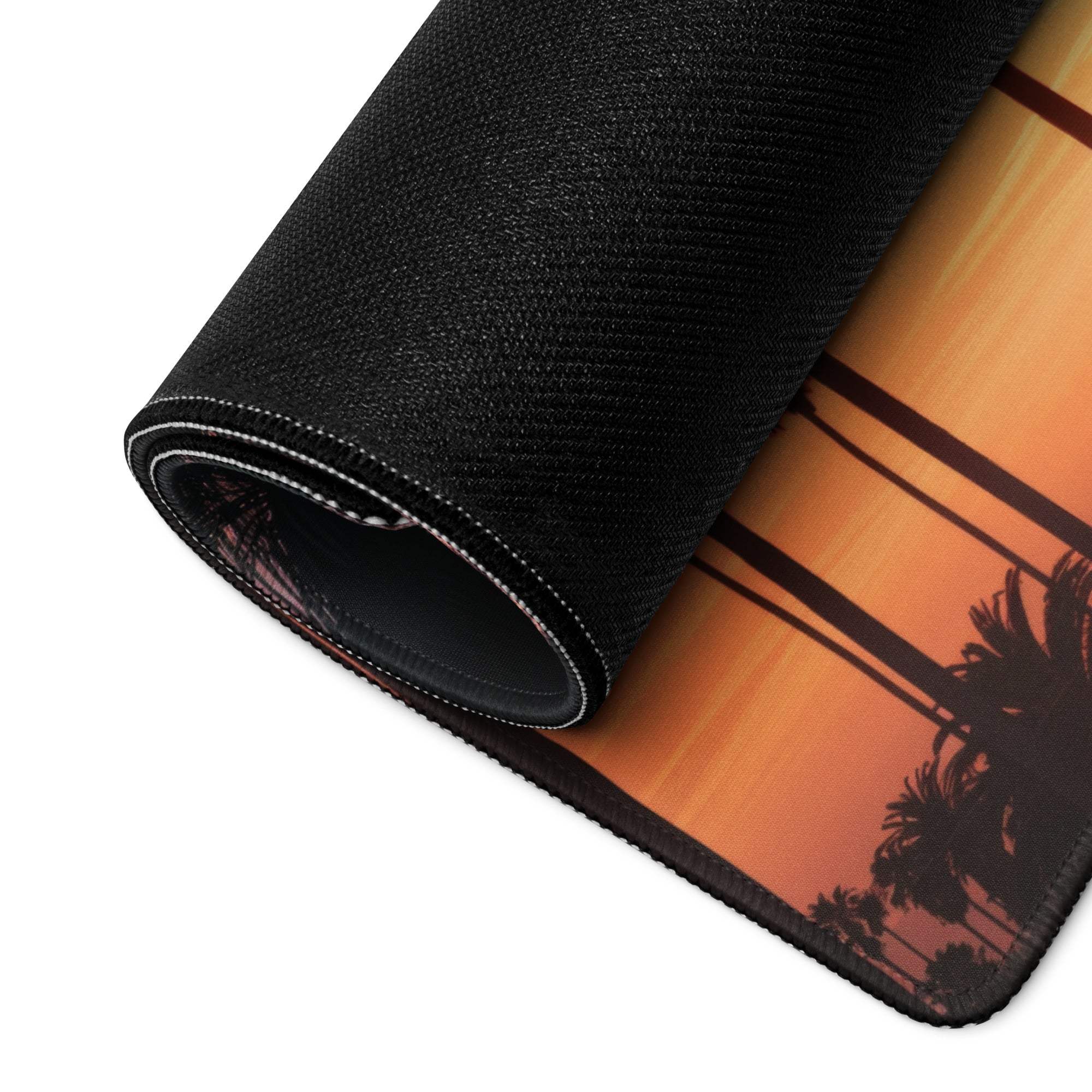 Black rolled-up mousepad with orange sunset palm tree silhouette
