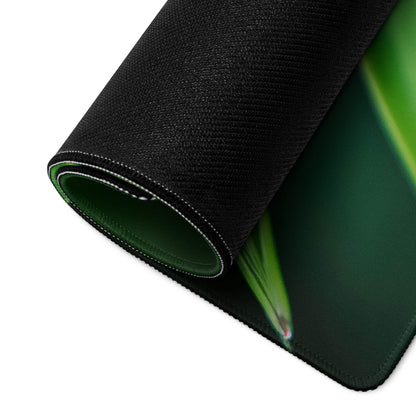 Large black gaming mousepad with green leaf design, stitched edges, non-slip base