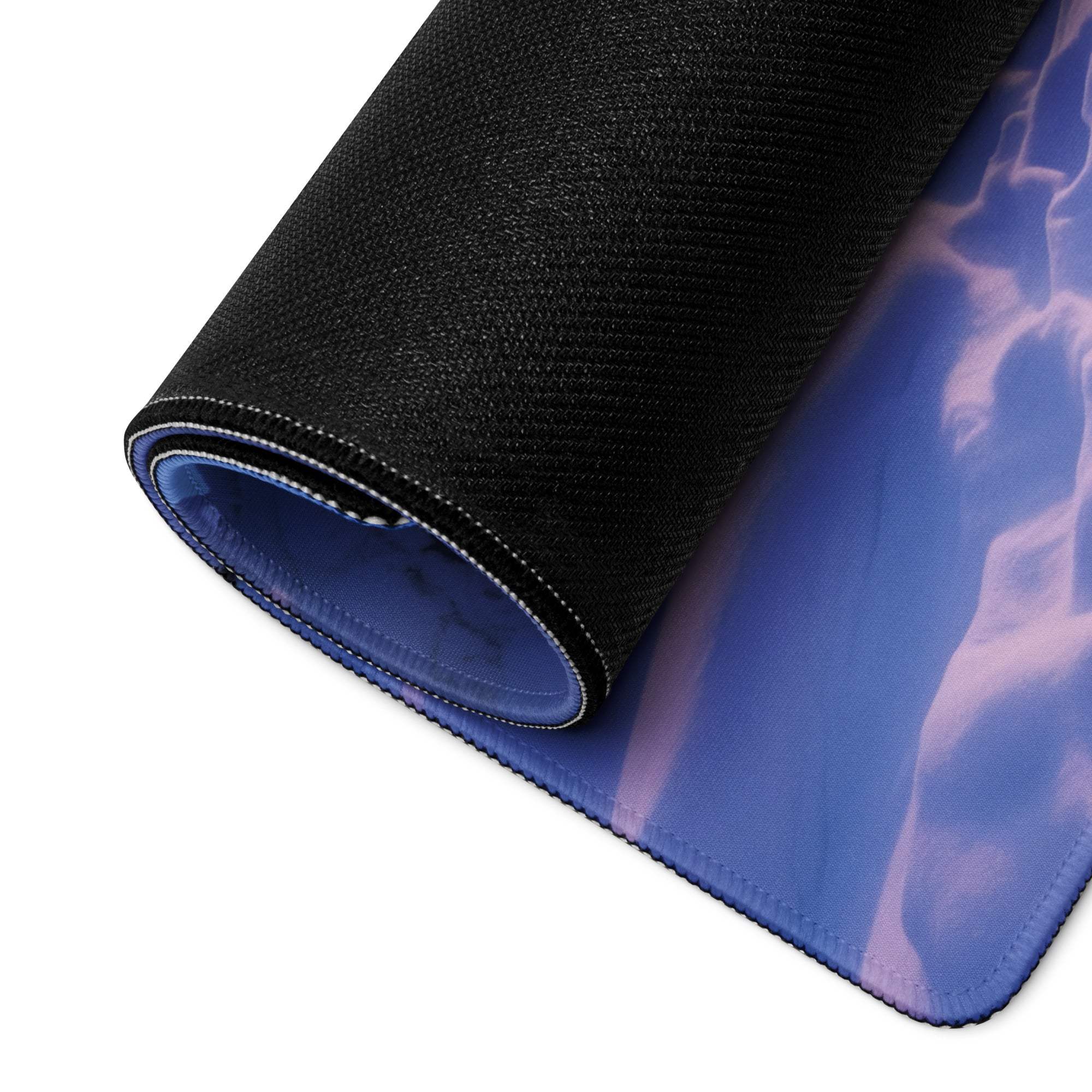 Rolled-up large icy purple sunset gaming mouse pad with blue wave design