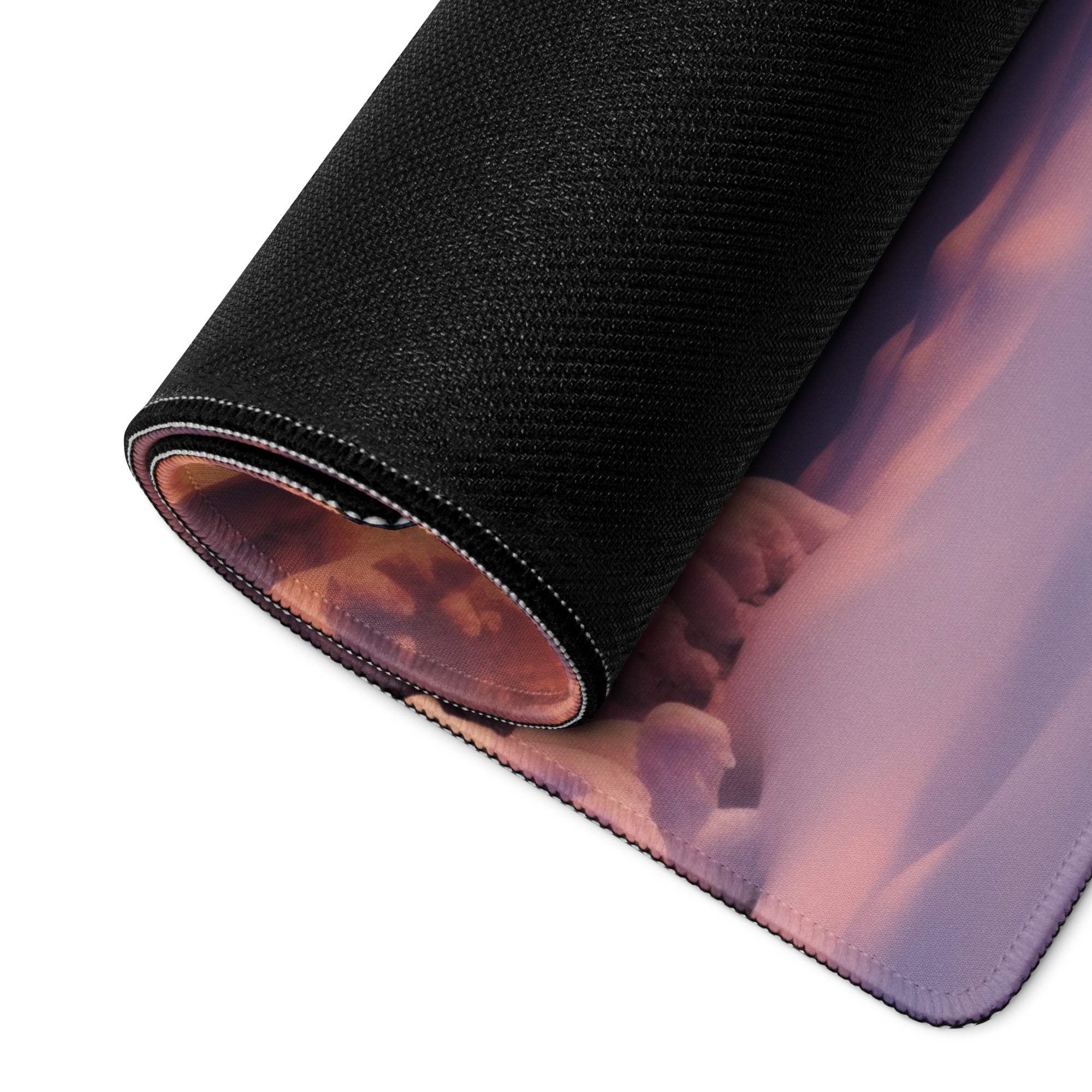 Black textured mousepad with rolled edge, pink-purple clouds and orange sunset glow
