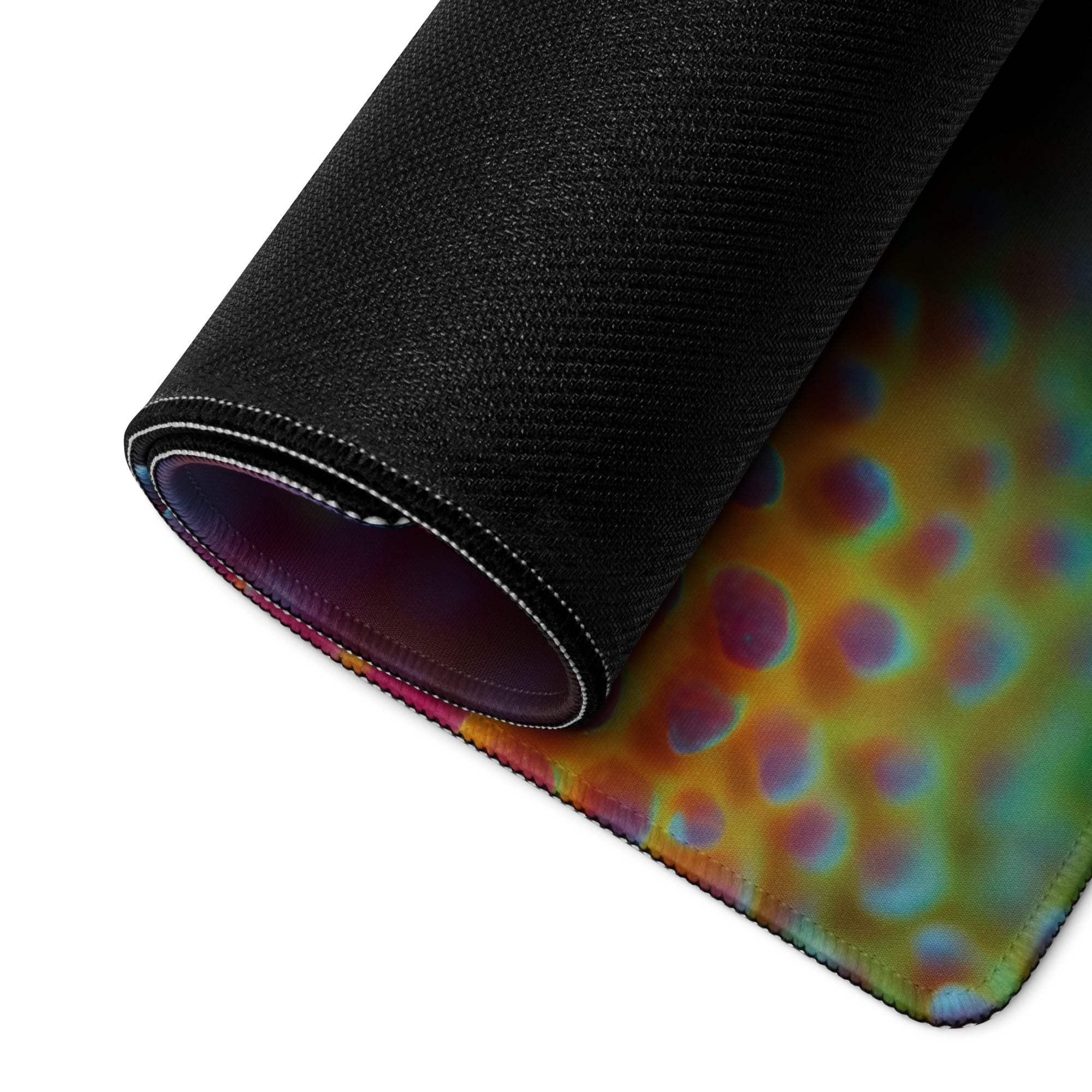 Vibrant coral reef gaming mouse pad rolled up with iridescent swirls