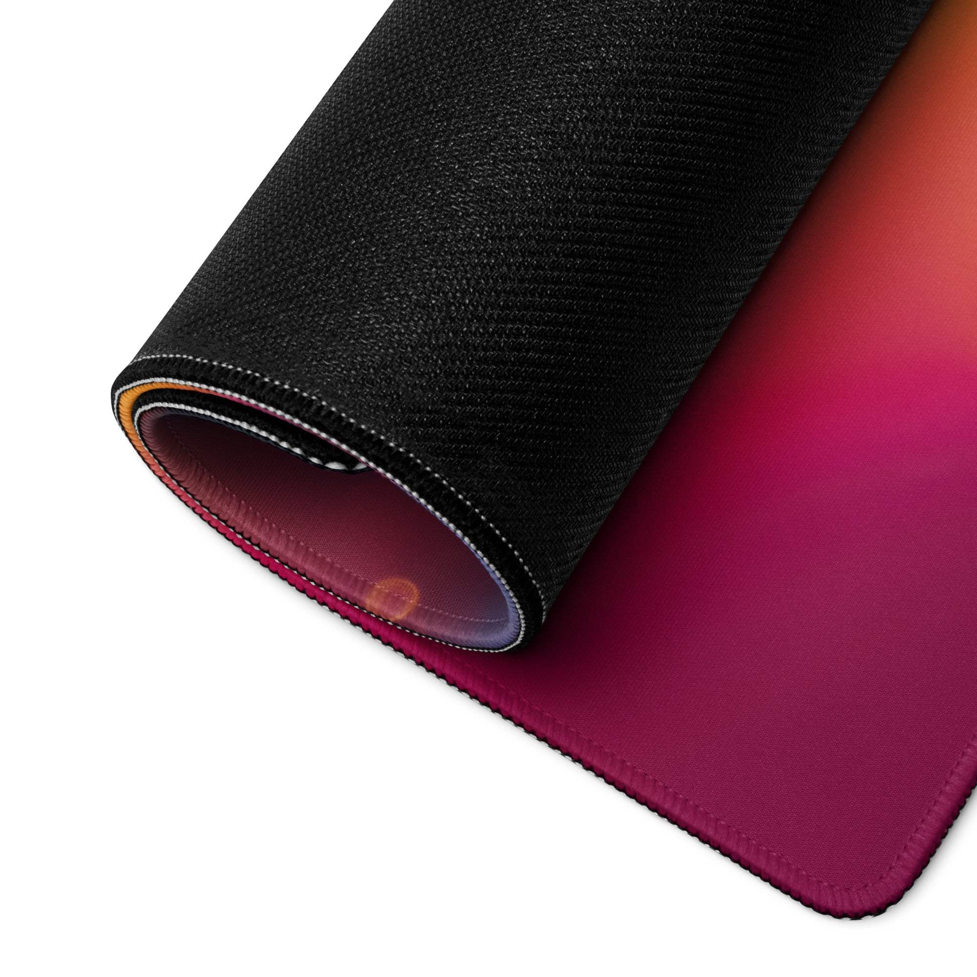 Rolled-up black textured Vivid Neon Gradient gaming mouse pad, magenta to orange