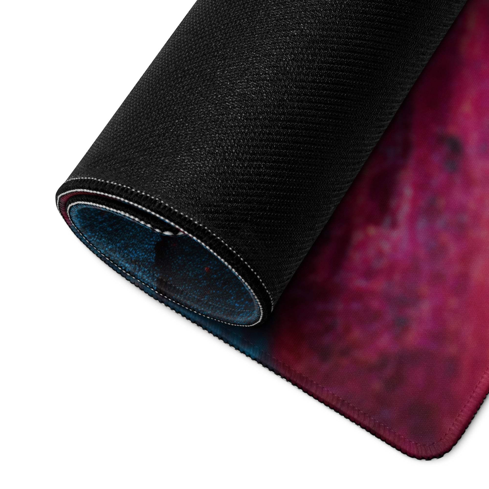 Rolled-up vibrant lava neon blue pink gaming mouse pad with cosmic design