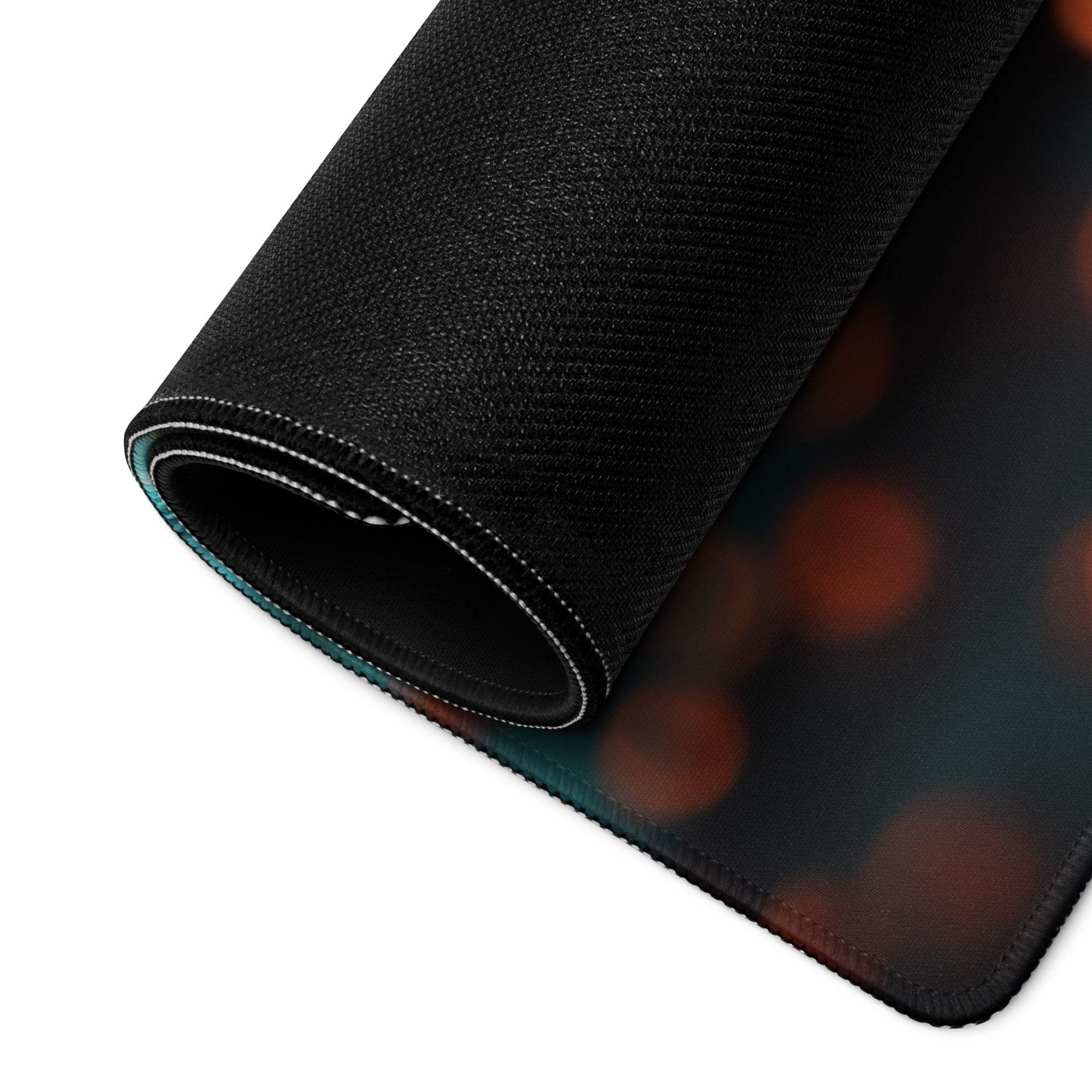 Large black textured gaming mousepad with orange teal bokeh glow