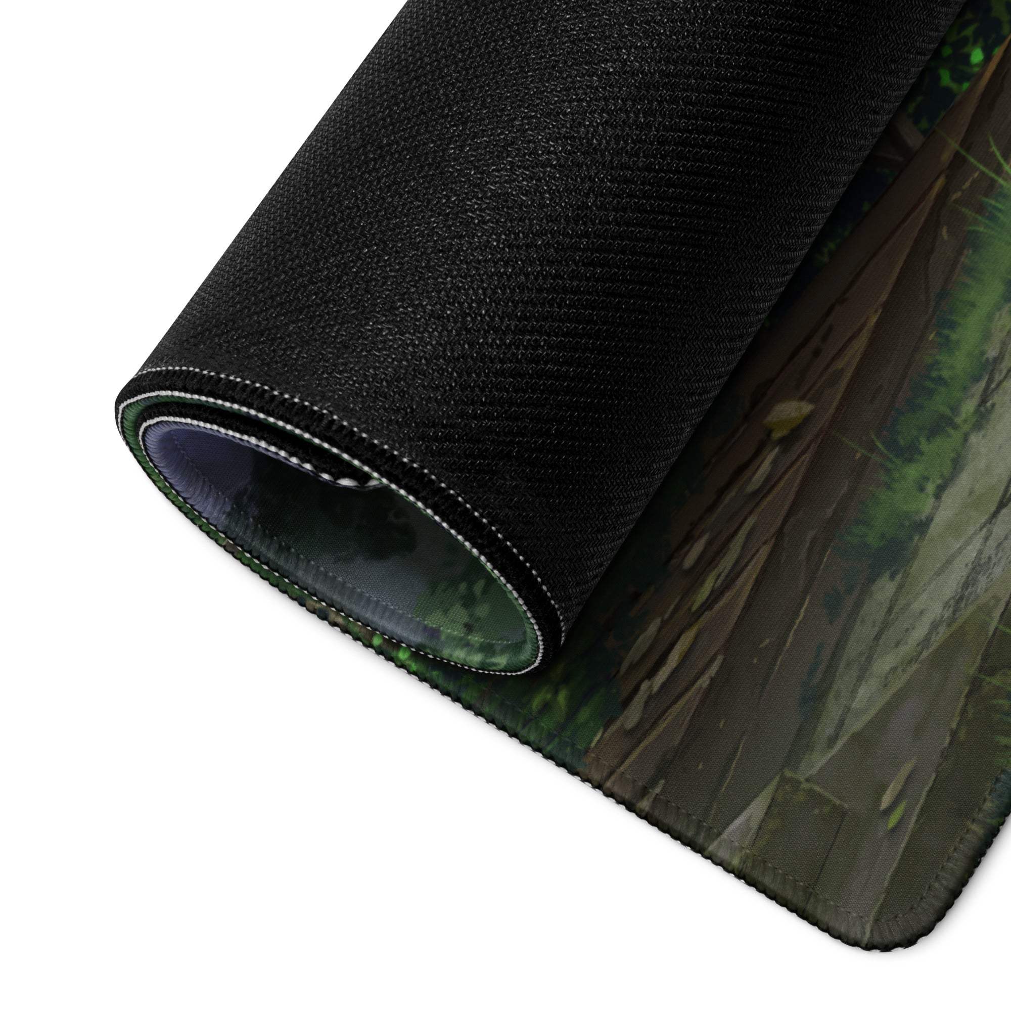 Black textured fabric mouse pad rolled up with a detailed green and brown verdant jungle scene design