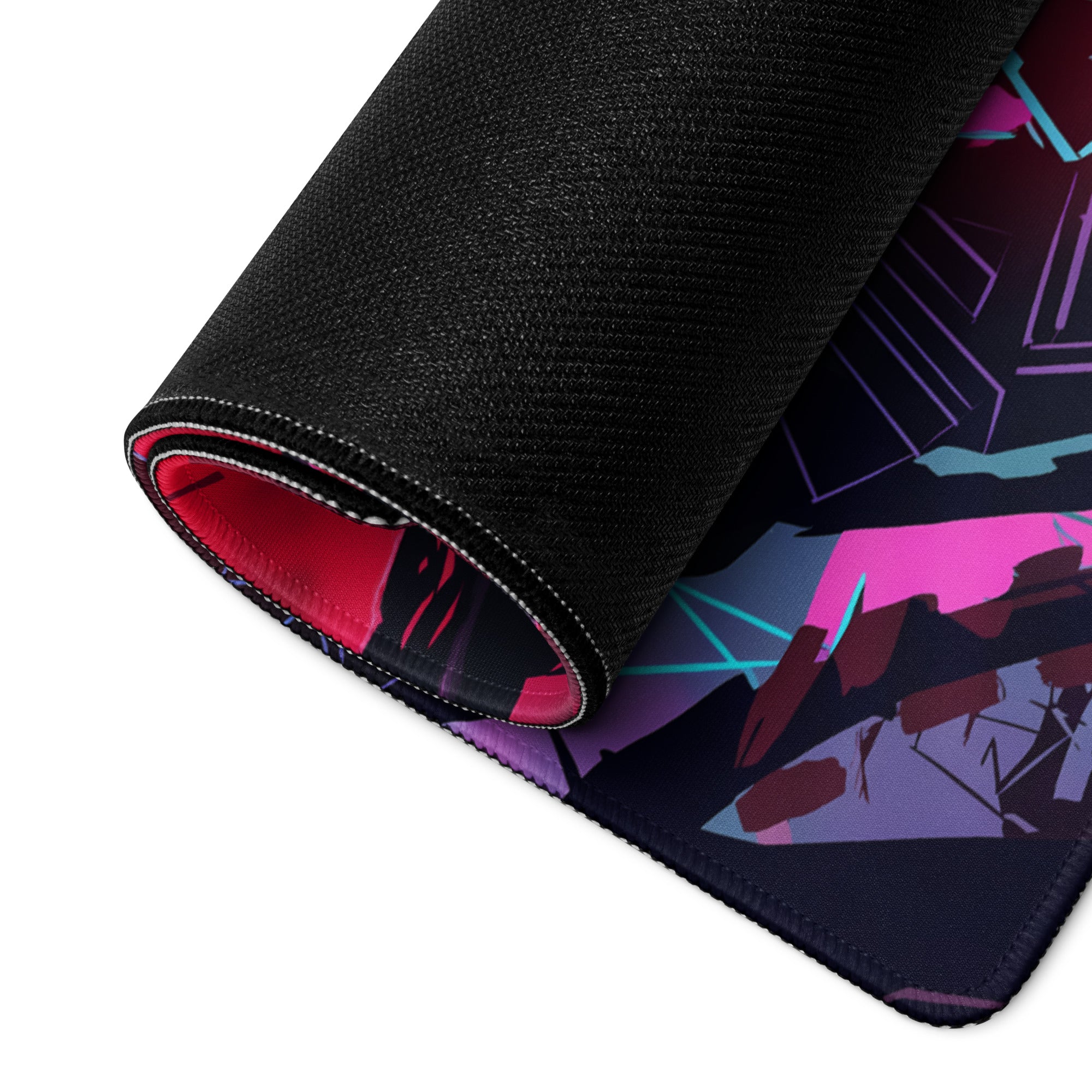 A rolled-up vaporwave neon cyber mouse pad with vibrant pink purple and teal geometric design on dark background