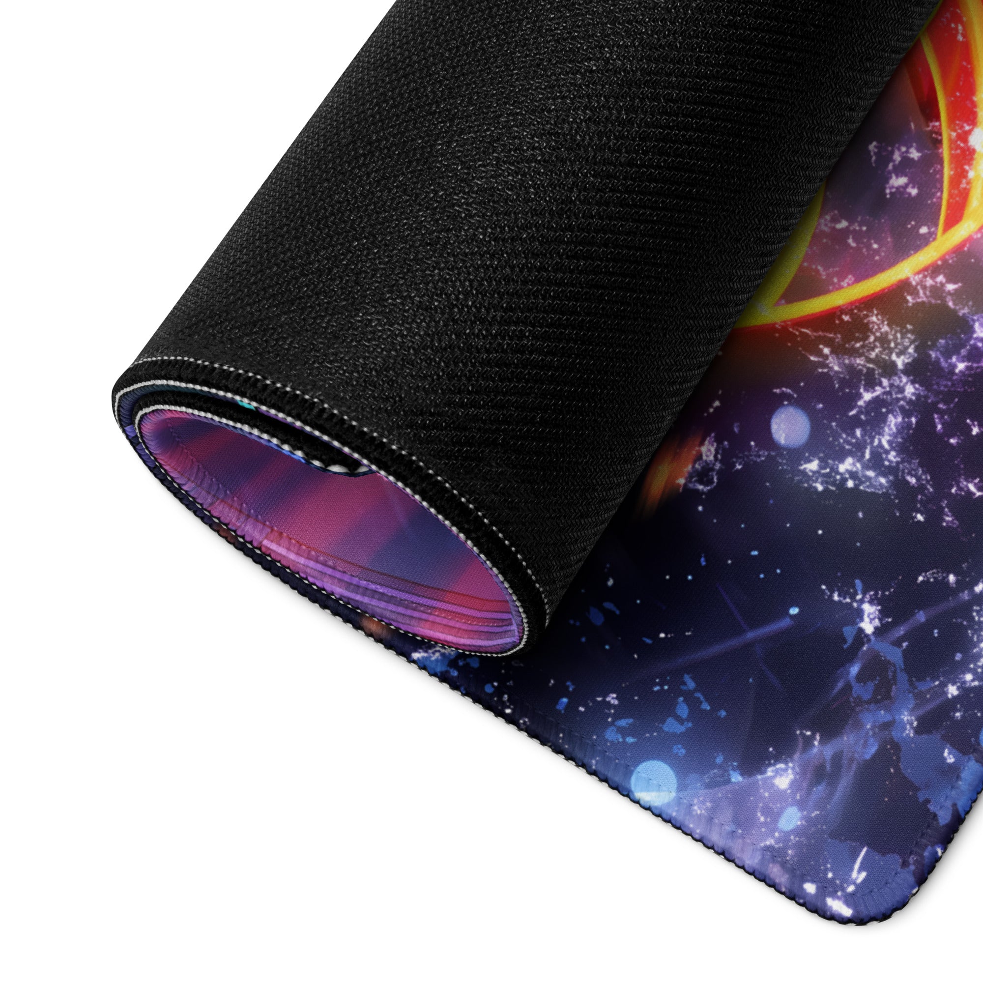 A rolled-up neon vaporwave gaming mouse pad with vibrant purple blue and orange cosmic nebula design on fabric surface