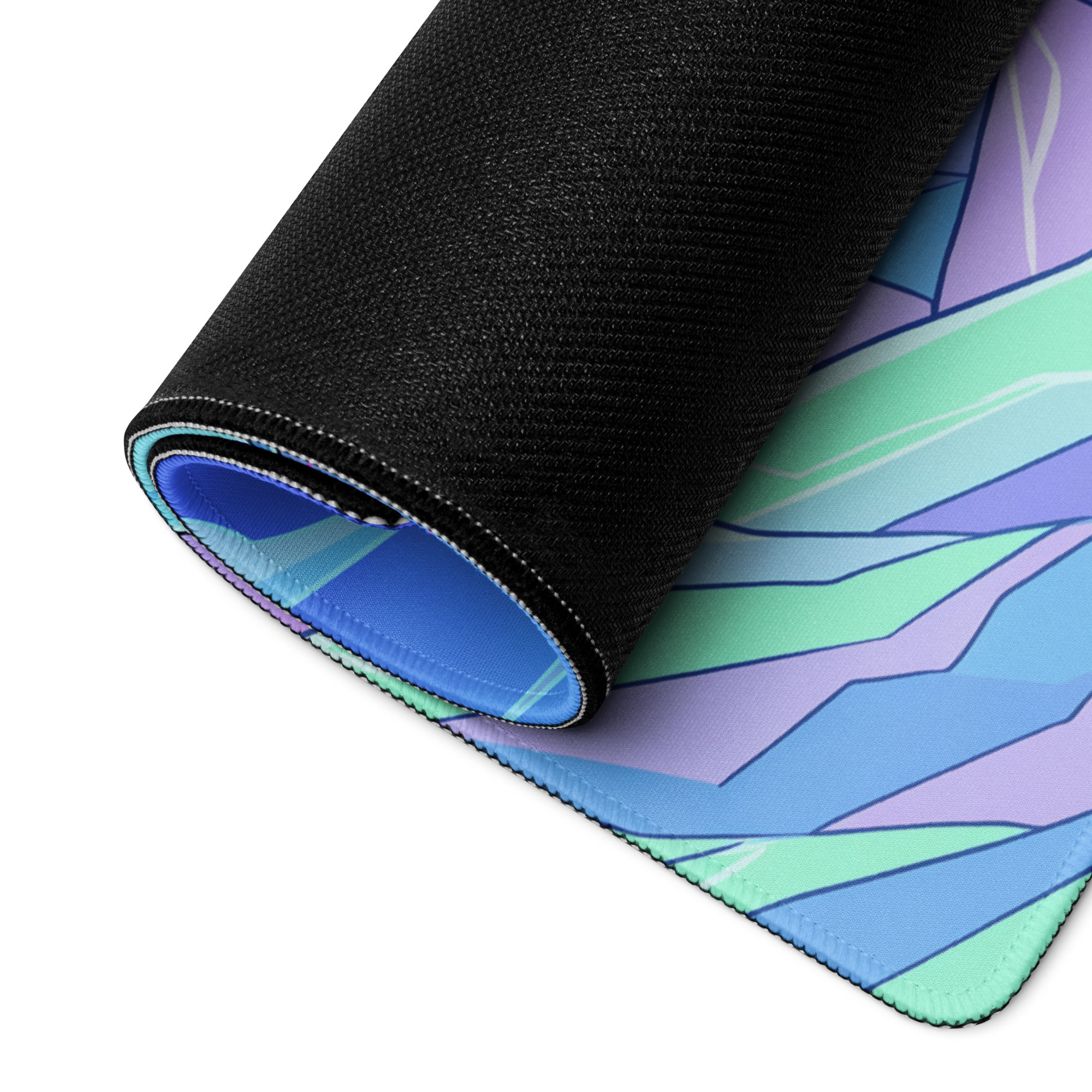 A rolled up neon dragon vaporwave gaming mousepad with vibrant blue green and purple geometric design for desk use