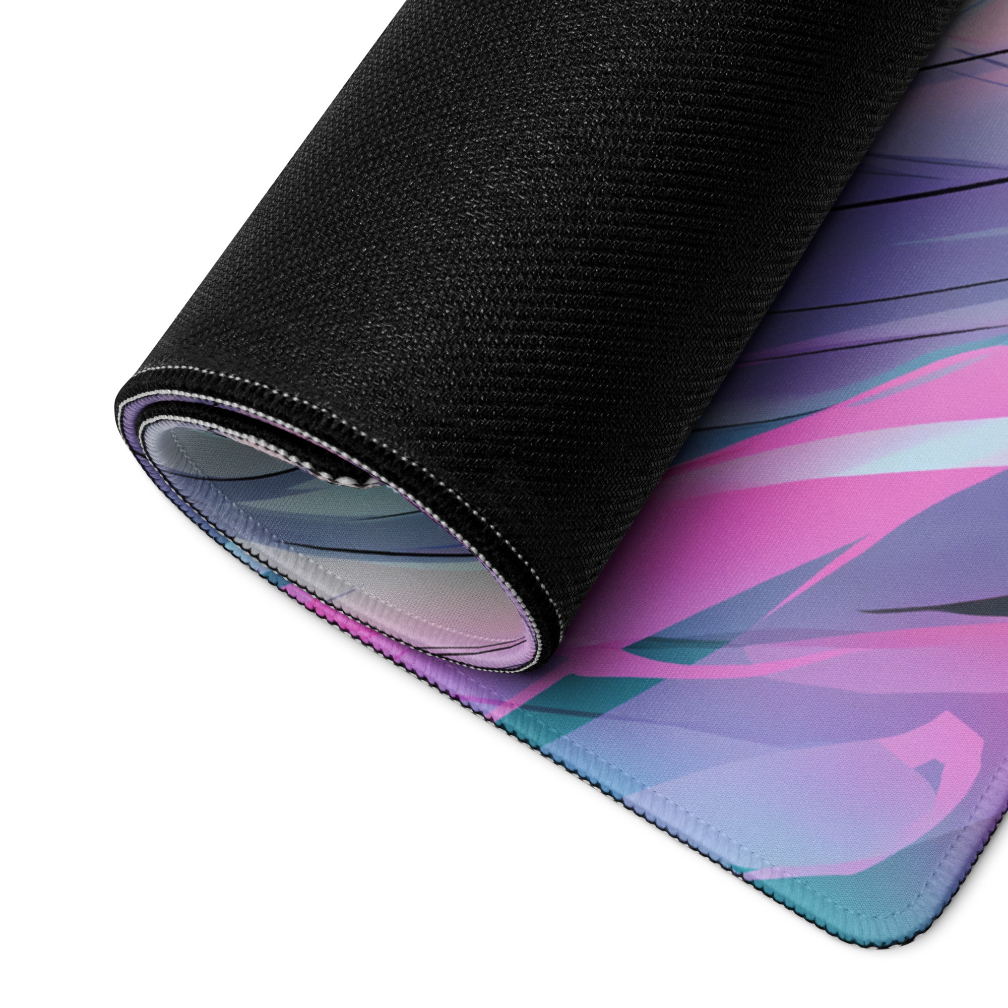 A rolled-up aether wings vaporwave gaming mouse pad with vibrant pink purple and teal neon angel wings on black surface