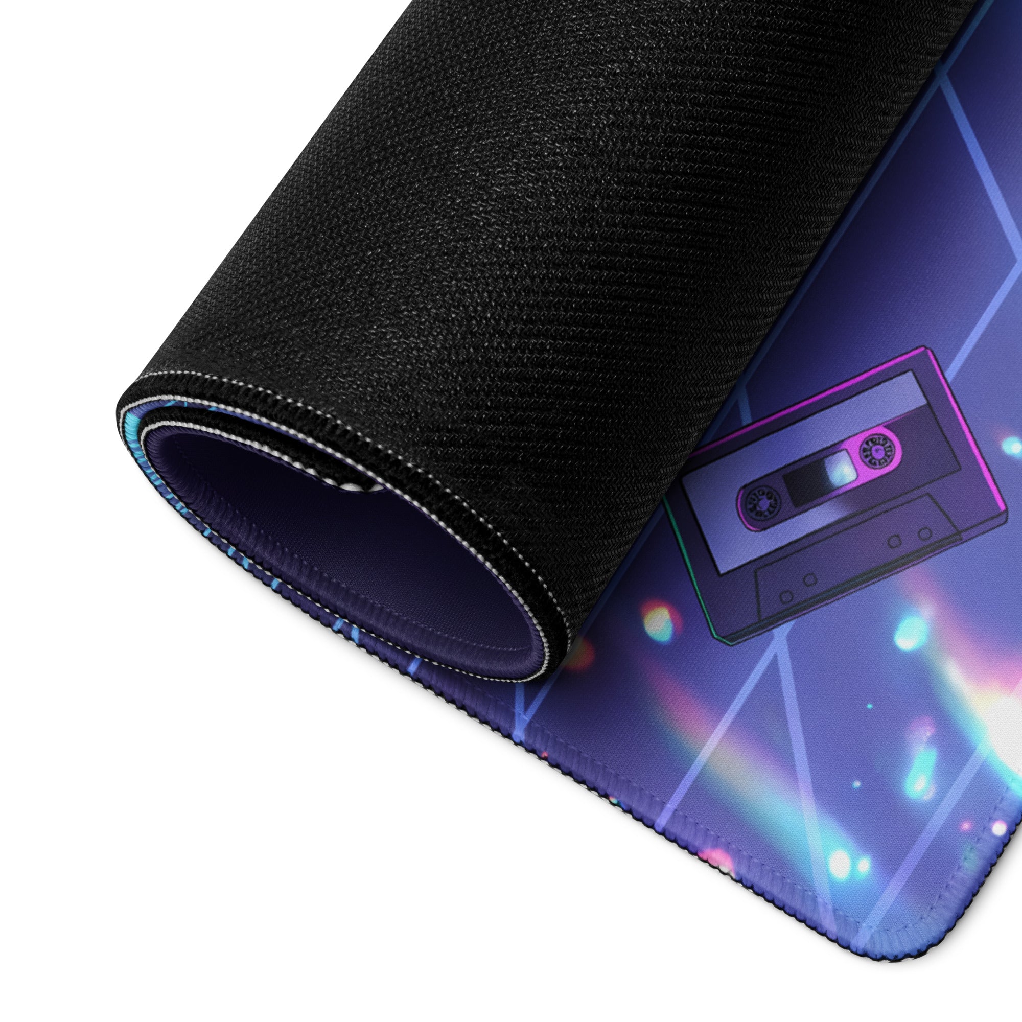A black rolled-up gaming mousepad with vibrant purple and blue neon vaporwave cassette tape design for cyber warriors