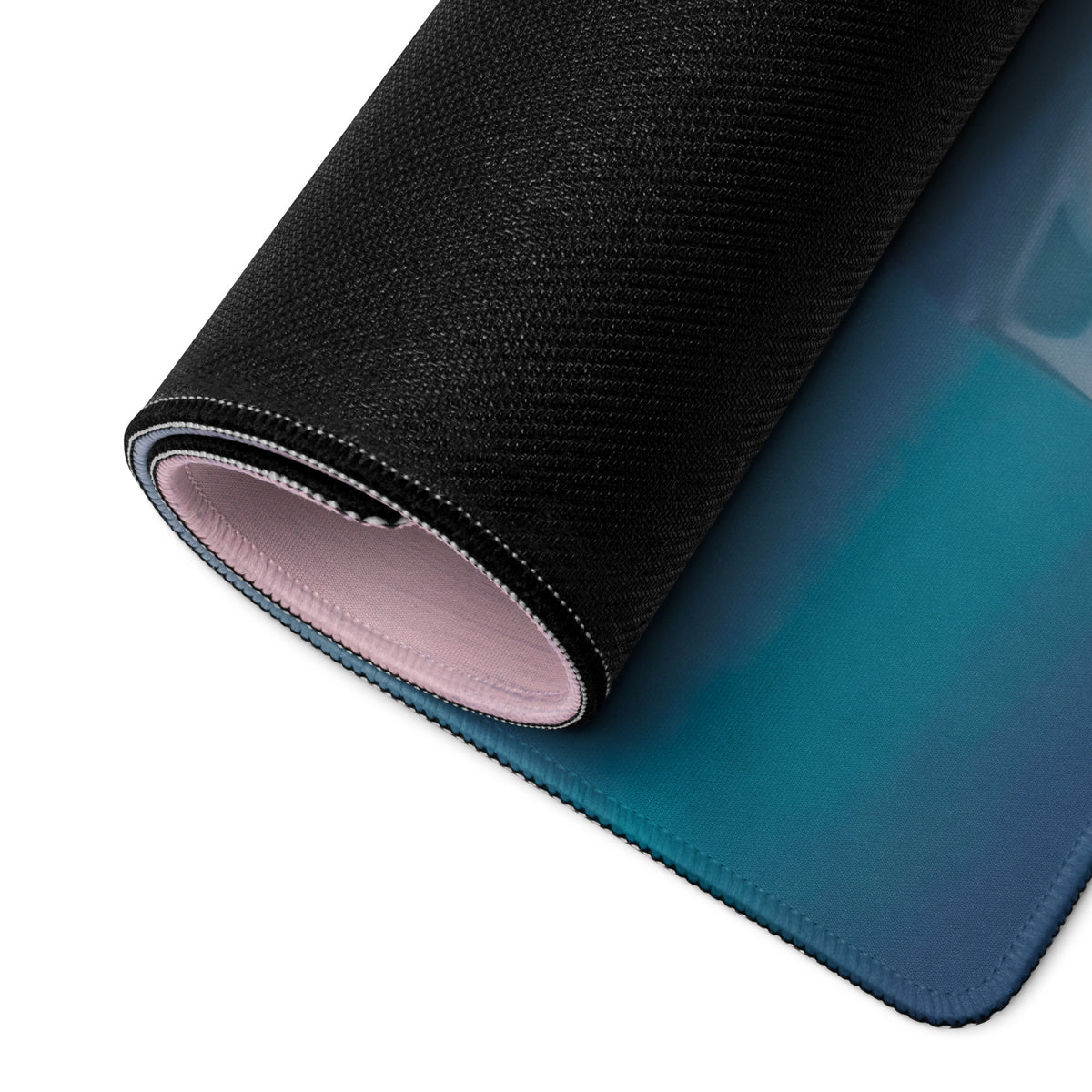 Black textured aston martin vantage inspired desk pad with gradient blue underside and pink stitched edge lining