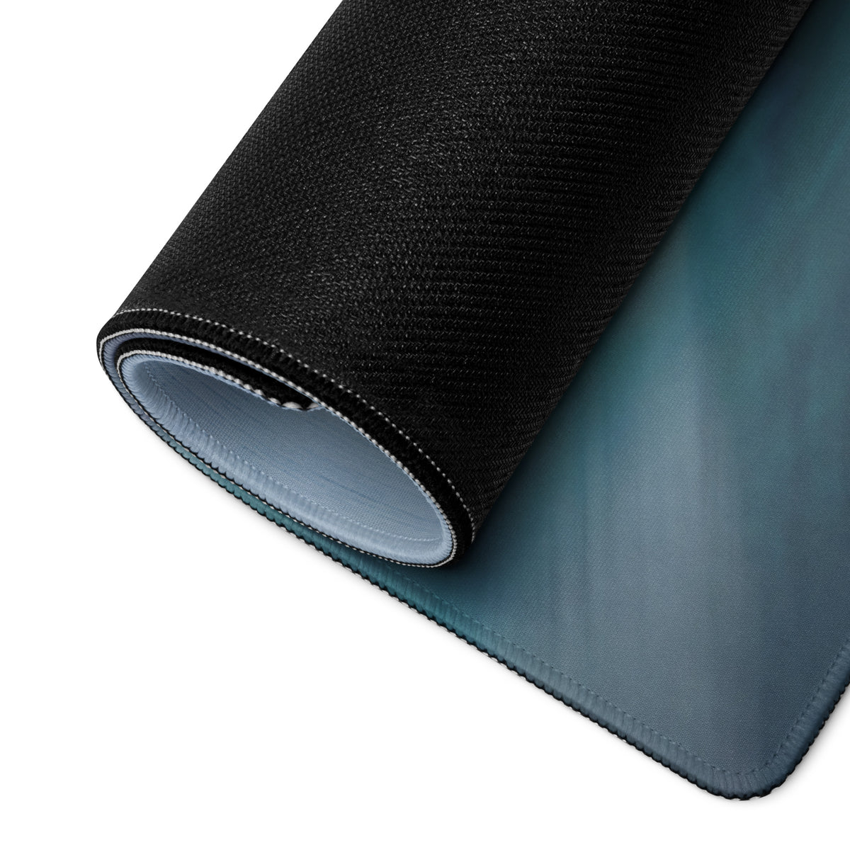 Black textured outer layer with smooth teal inner surface on a Ferrari 296 GT3 inspired low-friction cloth desk mat