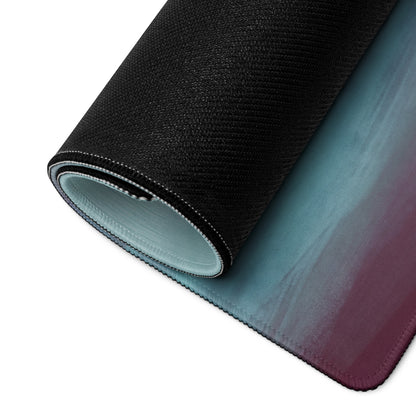 A rolled-up lamborghini centenario inspired carbon gold desk mat with a teal to deep purple gradient surface