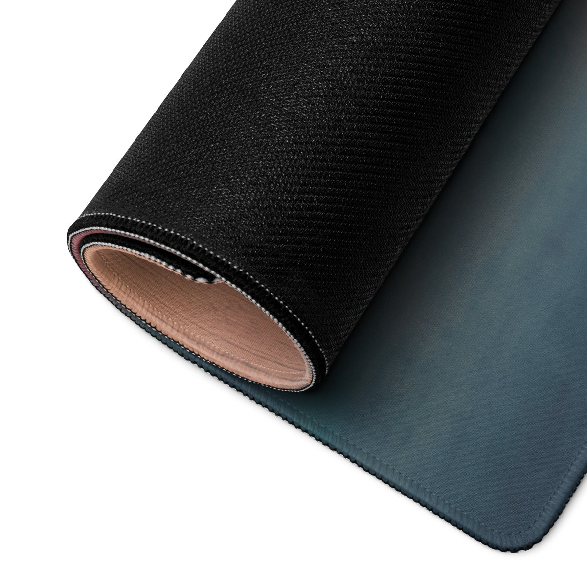 Black textured Porsche 911 GT3 inspired shark blue profile desk pad with subtle teal gradient underside rolled partially
