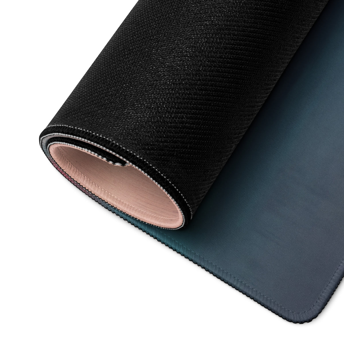 Black textured McLaren Senna inspired carbon stealth desk mat with soft pink lining and precise stitching for XL gaming use