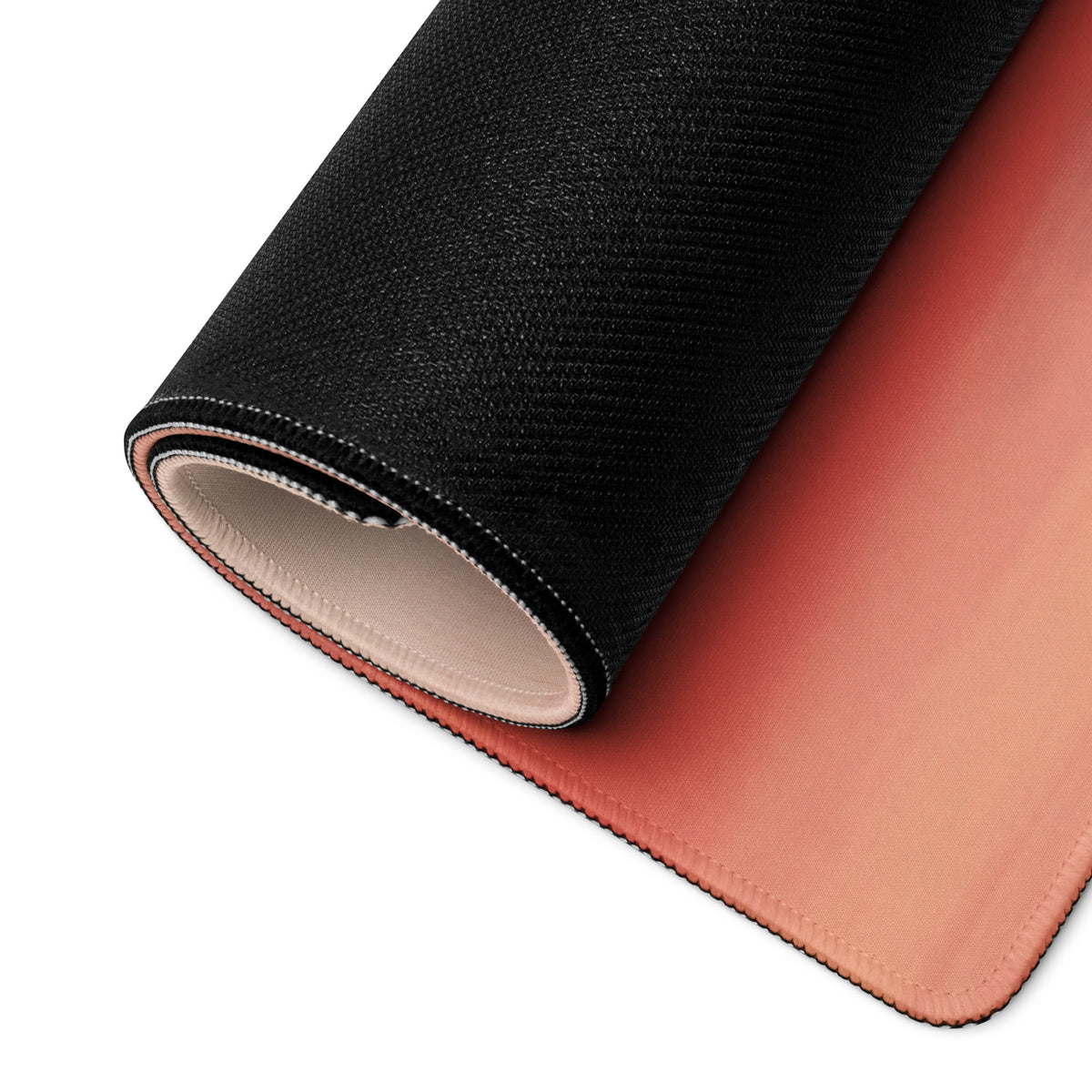 Yamaha r1 inspired extra large mouse pad with black textured outer layer and smooth peach inner surface rolled up