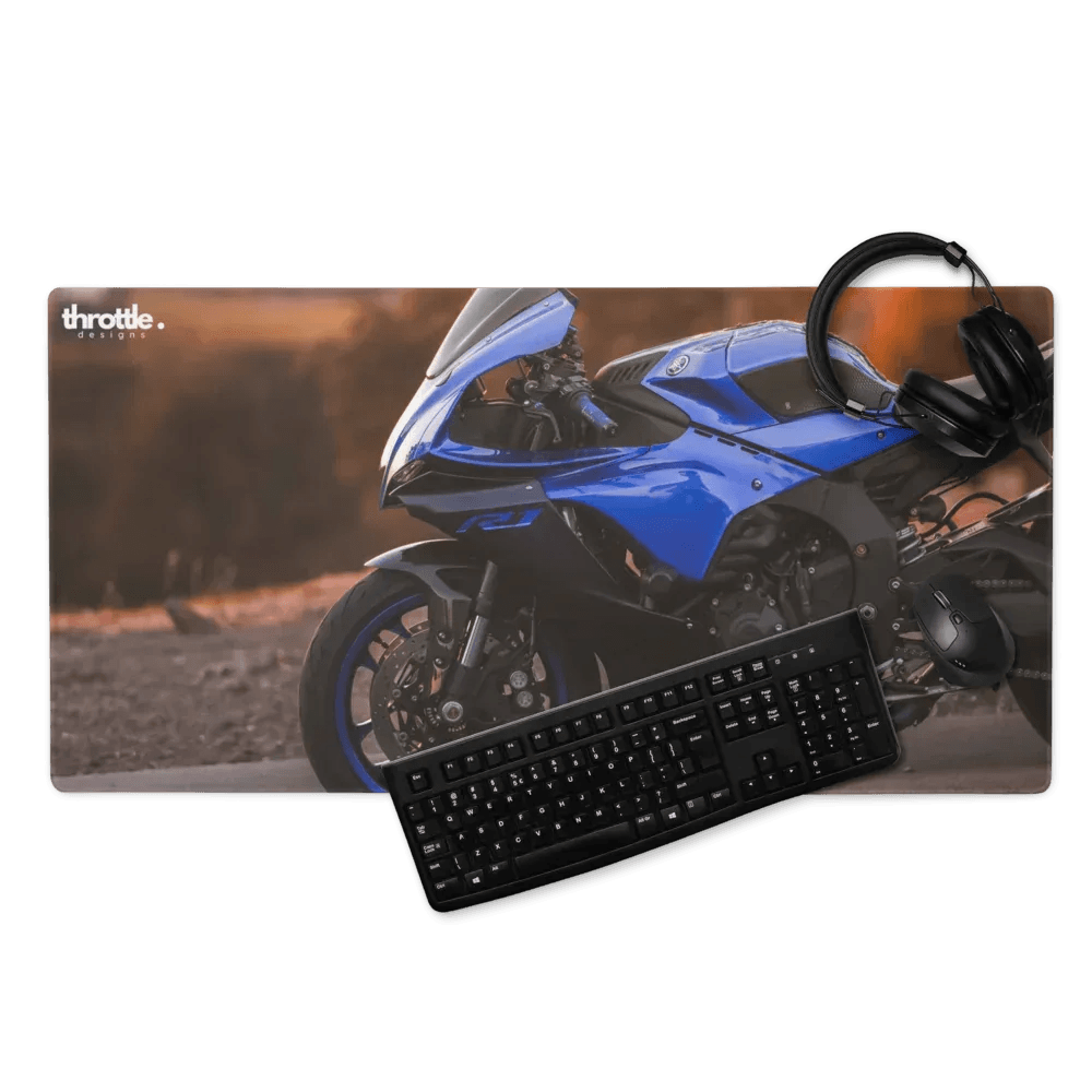 Blue yamaha r1 graphic on large gaming mouse pad with black keyboard and headset for extended desk use