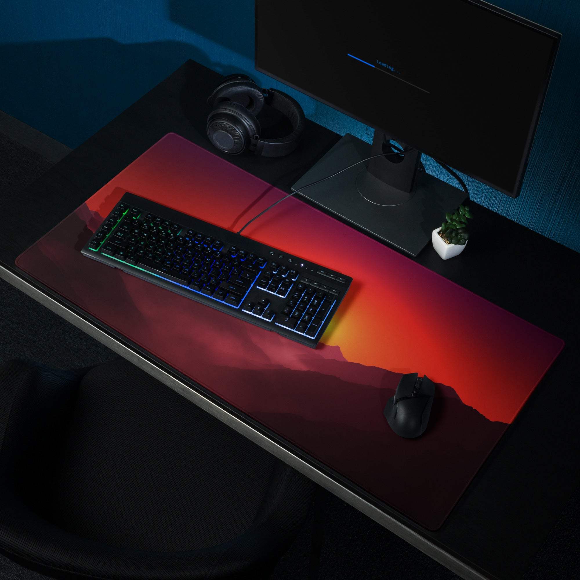 Vibrant sunset mountain vista gaming mouse pad with large non-slip surface under RGB keyboard