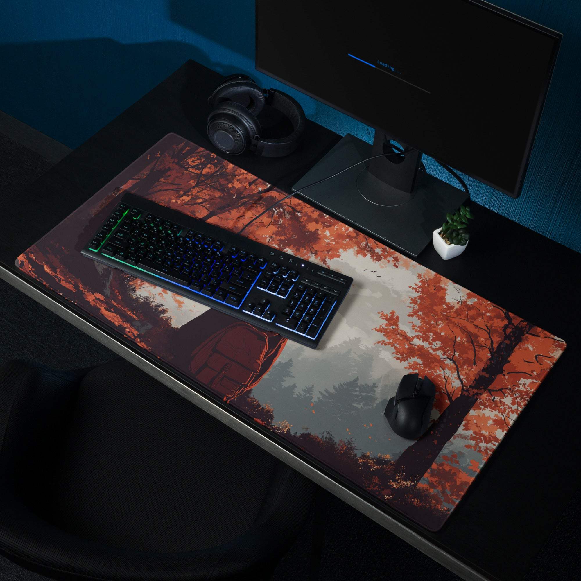 Large gaming mouse pad with stylized autumn forest backpacker scene in warm red tones
