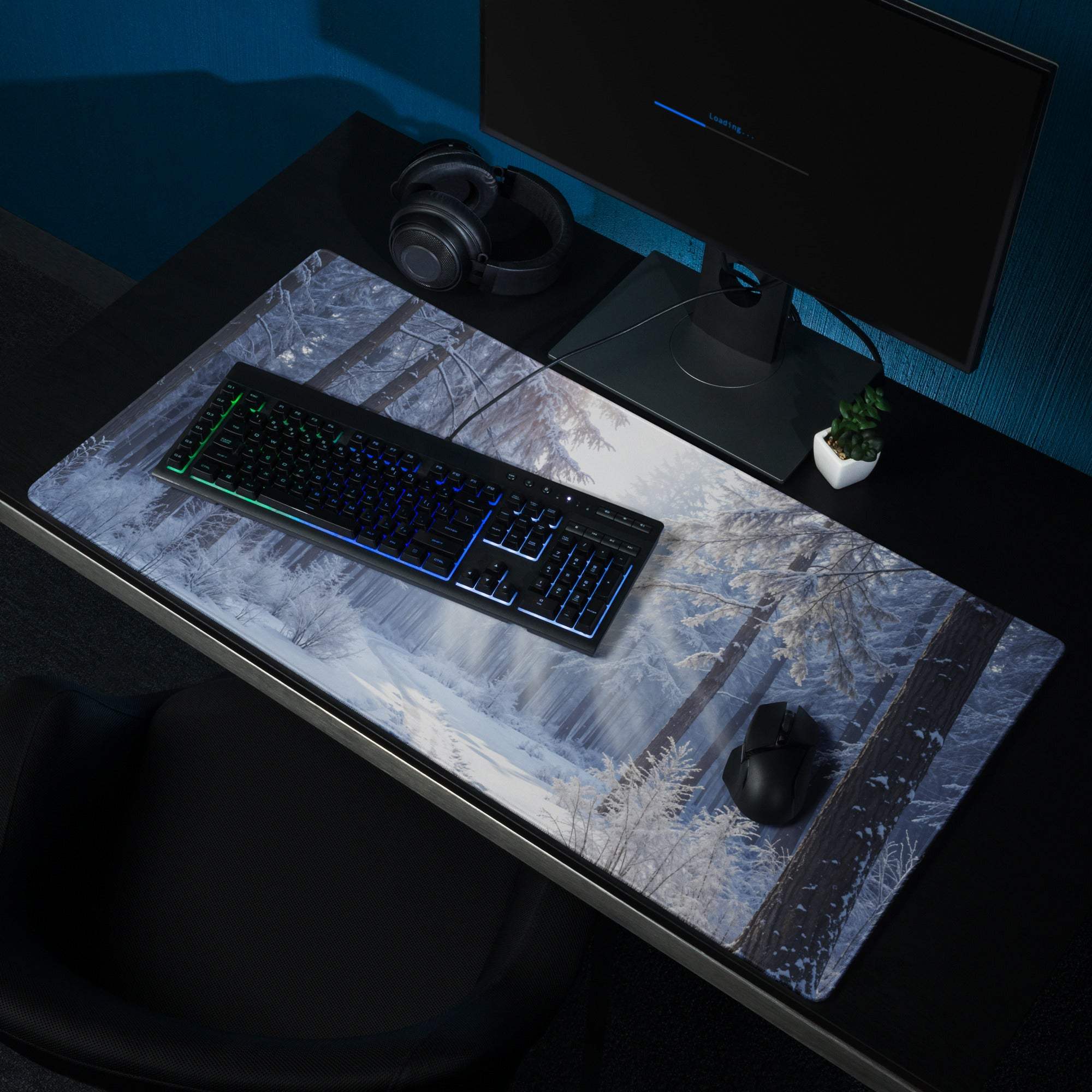 Large immersive winter forest gaming mouse pad with non-slip base on dark desk