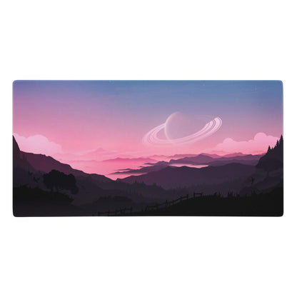 Rectangular gaming mousepad with a pink purple gradient featuring layered mountains and a glowing ringed planet