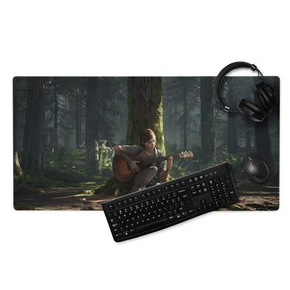 Black keyboard and mouse on Cinematic Forest Guitarist gaming mat