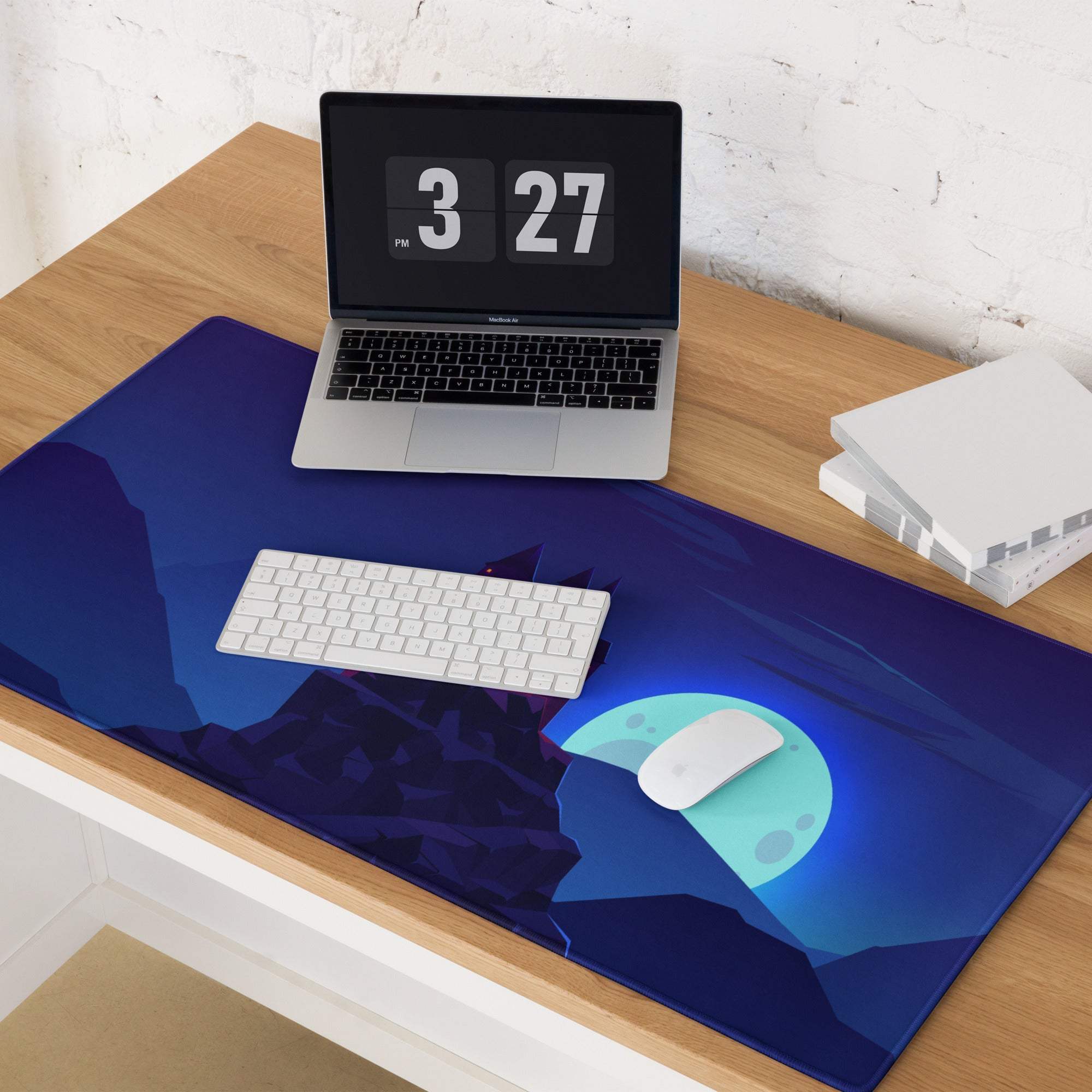 Blue mountain gaming mouse pad with glowing teal moon and fantasy castle design