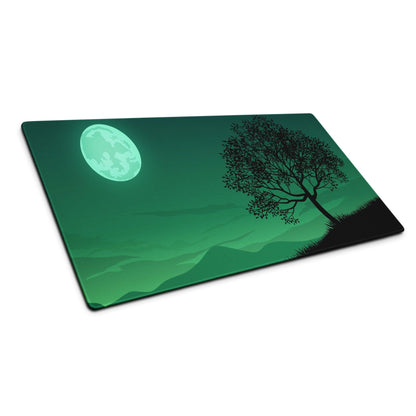 Green illustrated cutting board with glowing moon, tree silhouette, mountains on gaming mouse pad