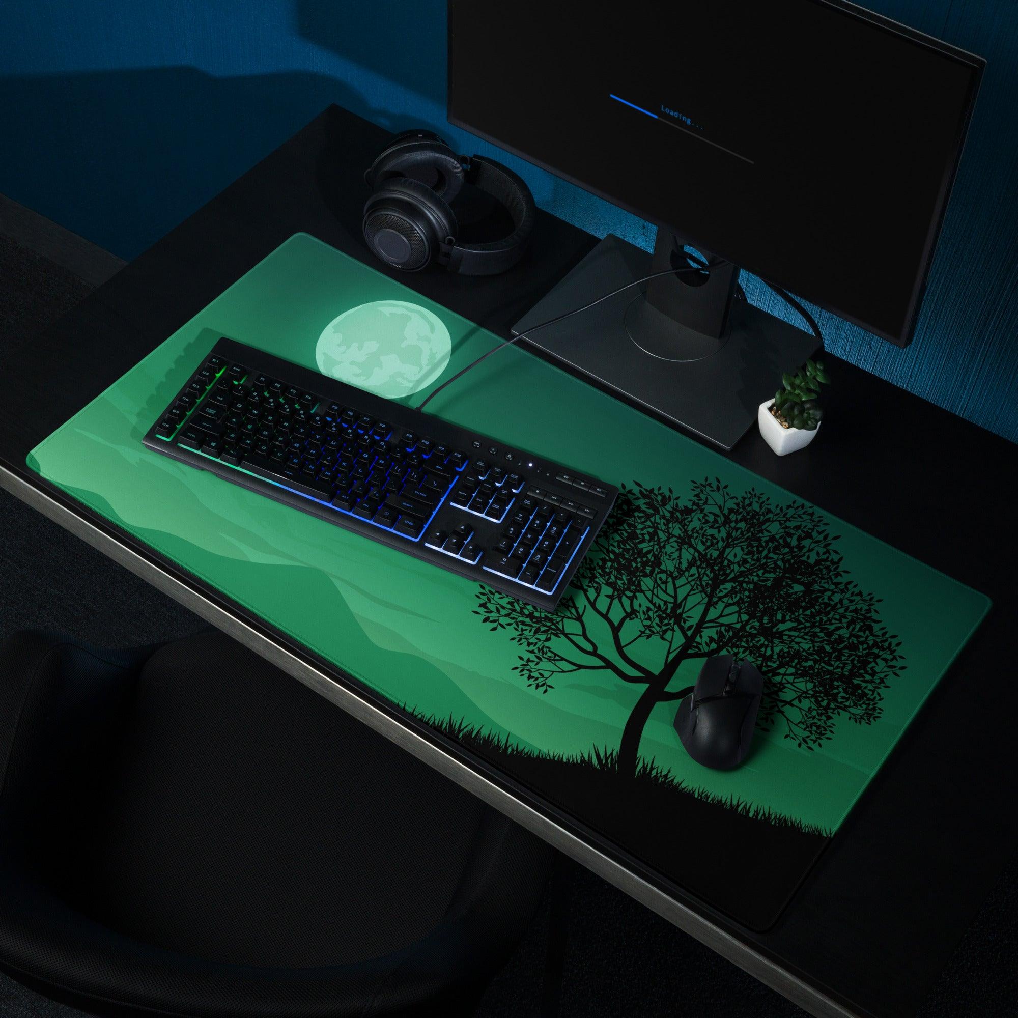 Green gaming mouse pad with black tree silhouette under moon, non-slip base
