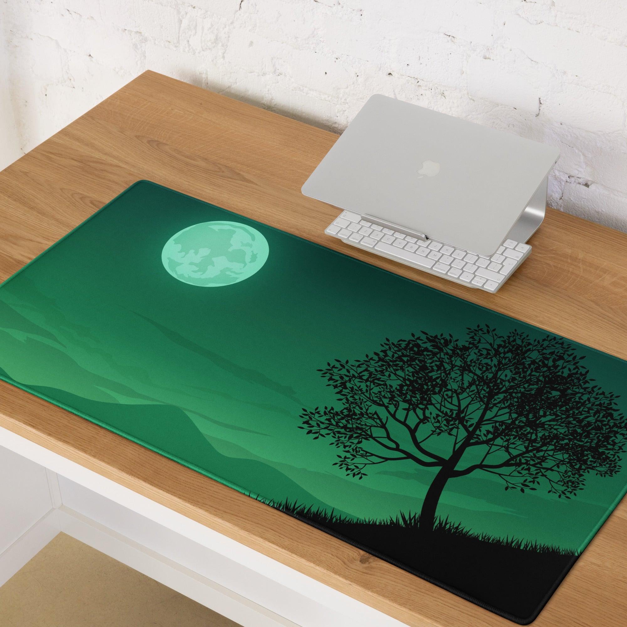 Green landscape gaming mouse pad with glowing teal moon and black tree silhouette