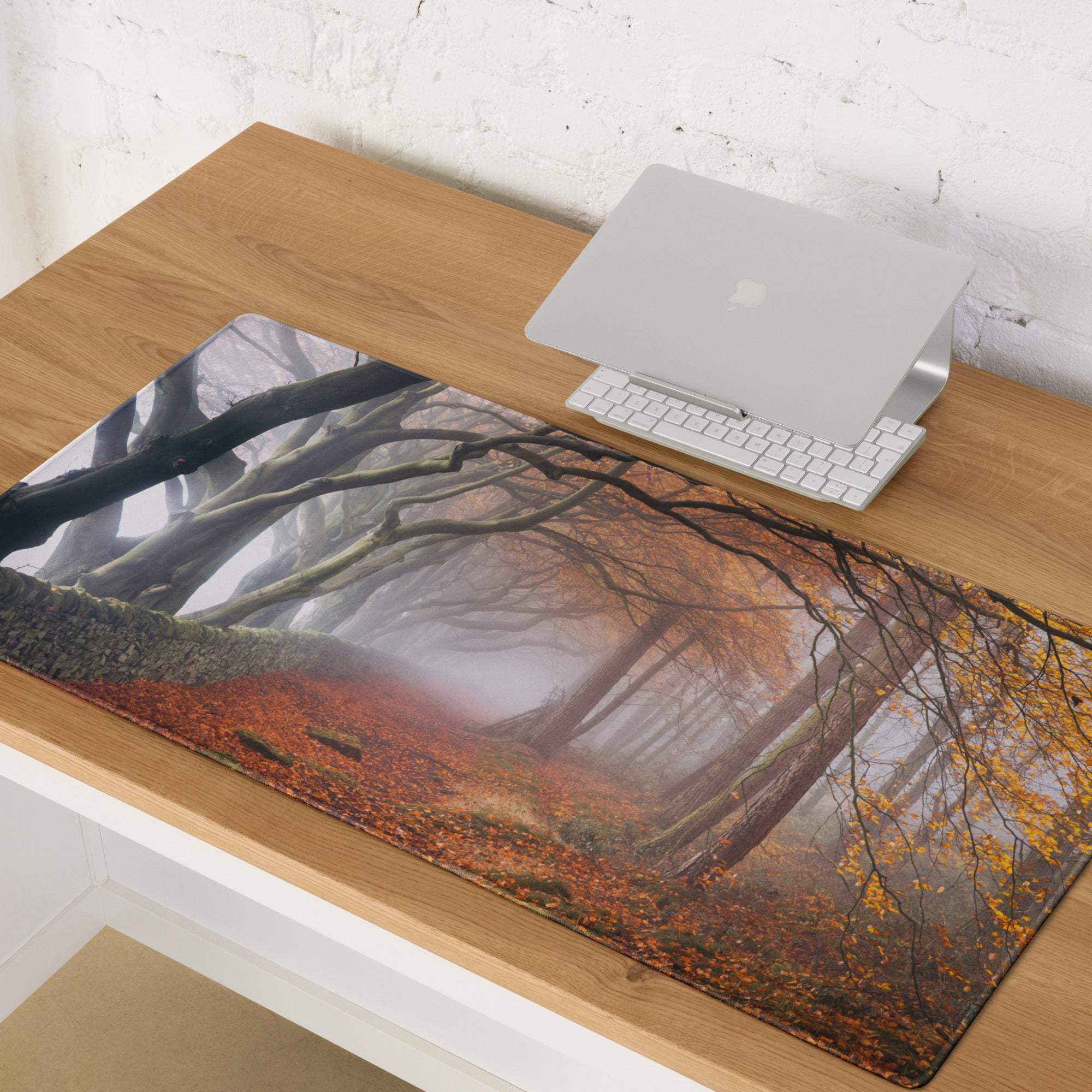 Nature-inspired autumn forest path gaming mouse pad with misty trees and fall leaves