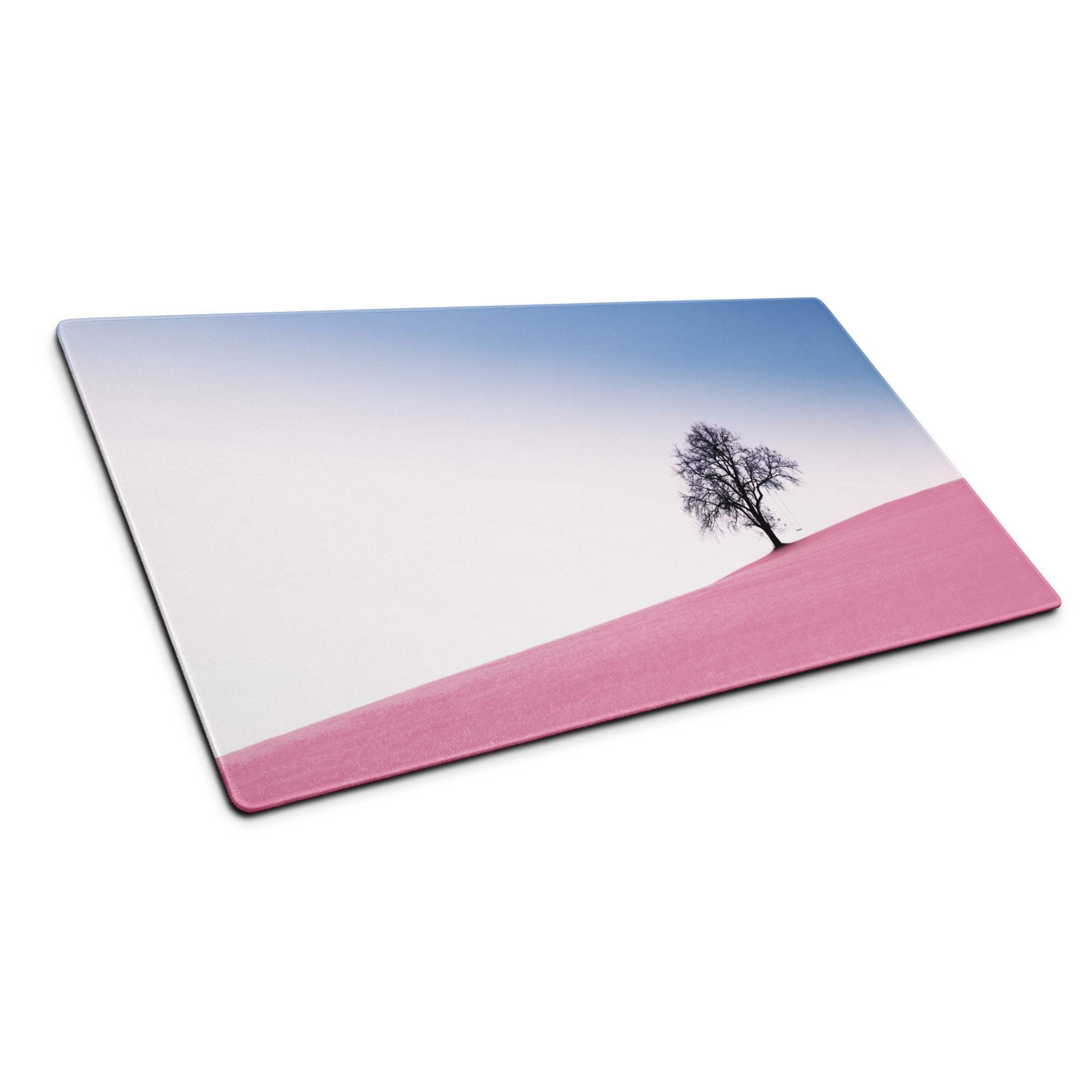 Large pastel pink landscape gaming mouse pad with tree silhouette and non-slip base