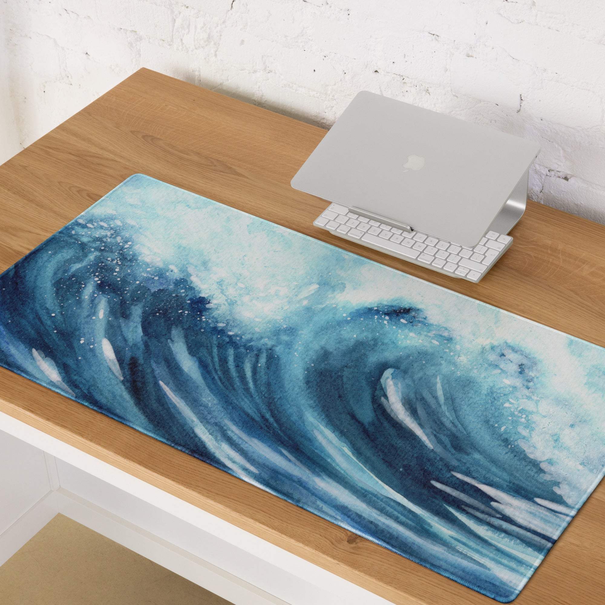 Blue watercolor ocean wave gaming mouse pad on wooden desk