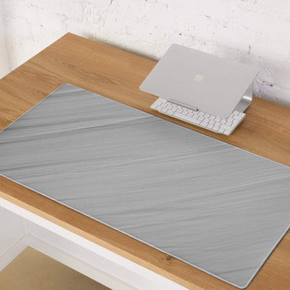 Gray marbled desk mat on wood, brushed aluminum gaming mouse pad view