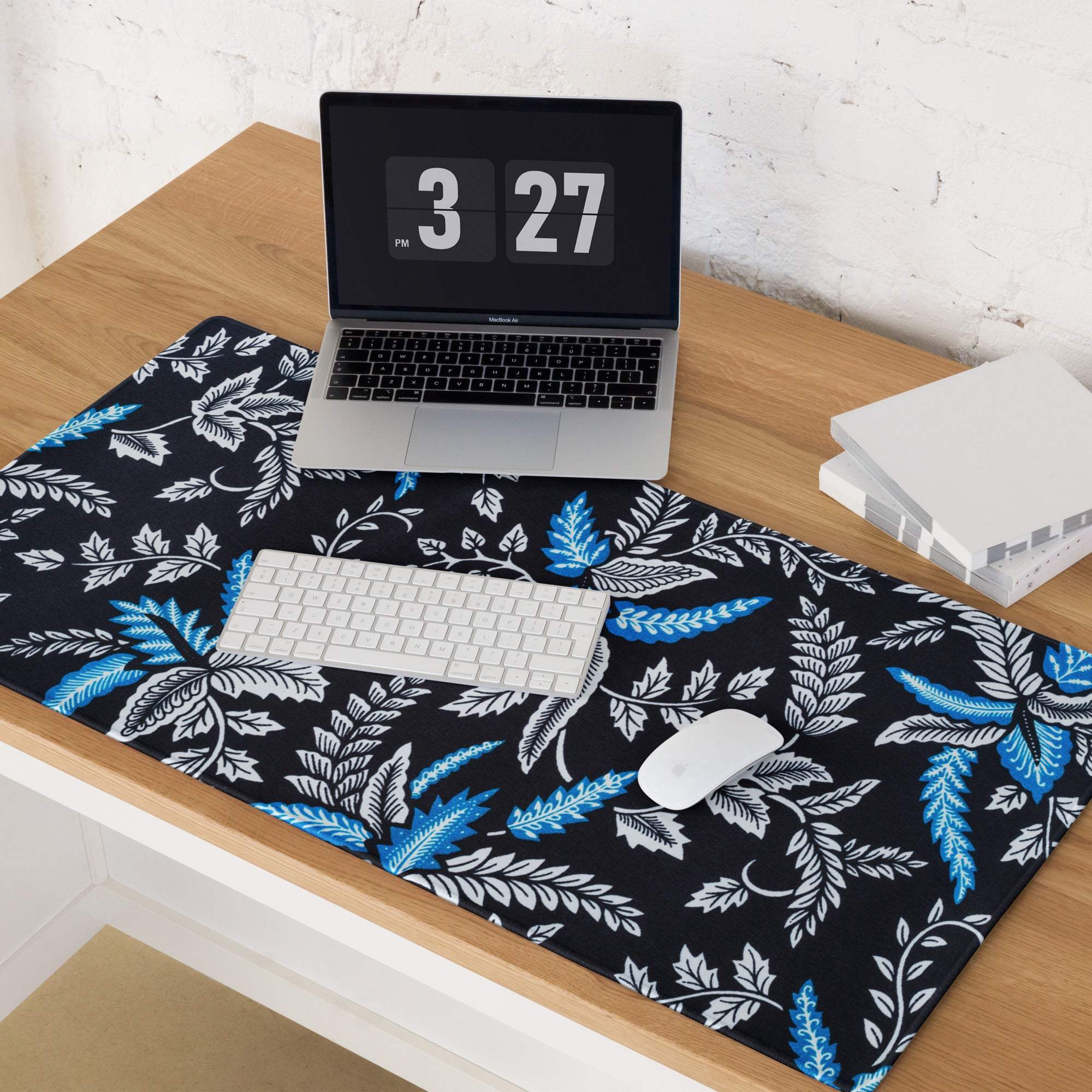 Black desk mat with vibrant blue white leaf pattern gaming mouse pad