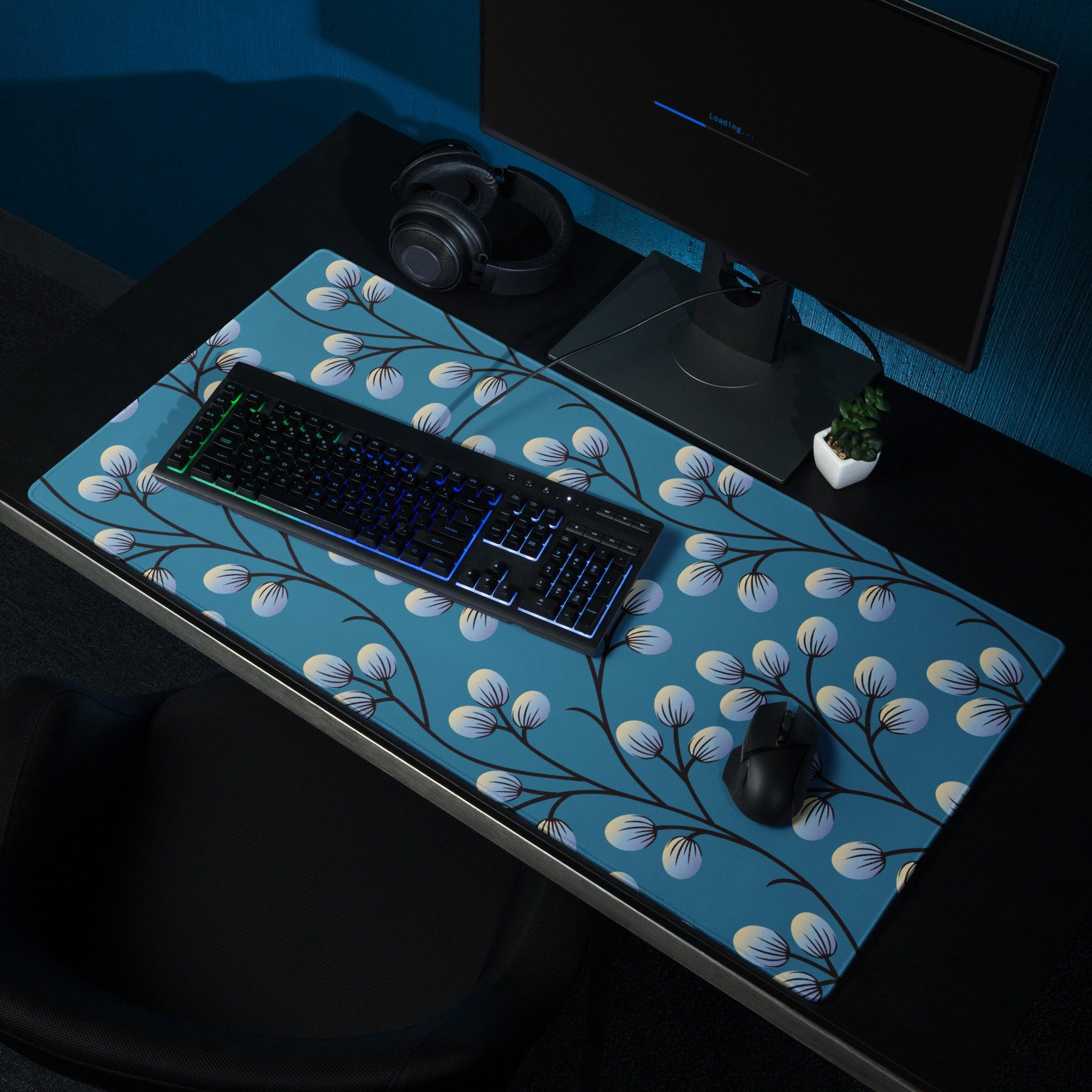 Blue floral desk mat with white blossoms, black branches on gaming mouse pad